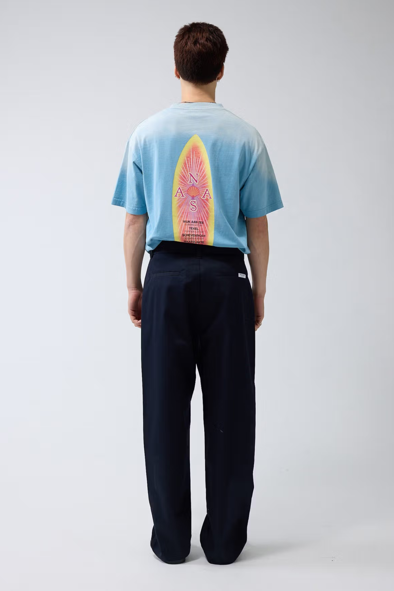 Model wearing the New Amsterdam reworked pants in night blue. Back view