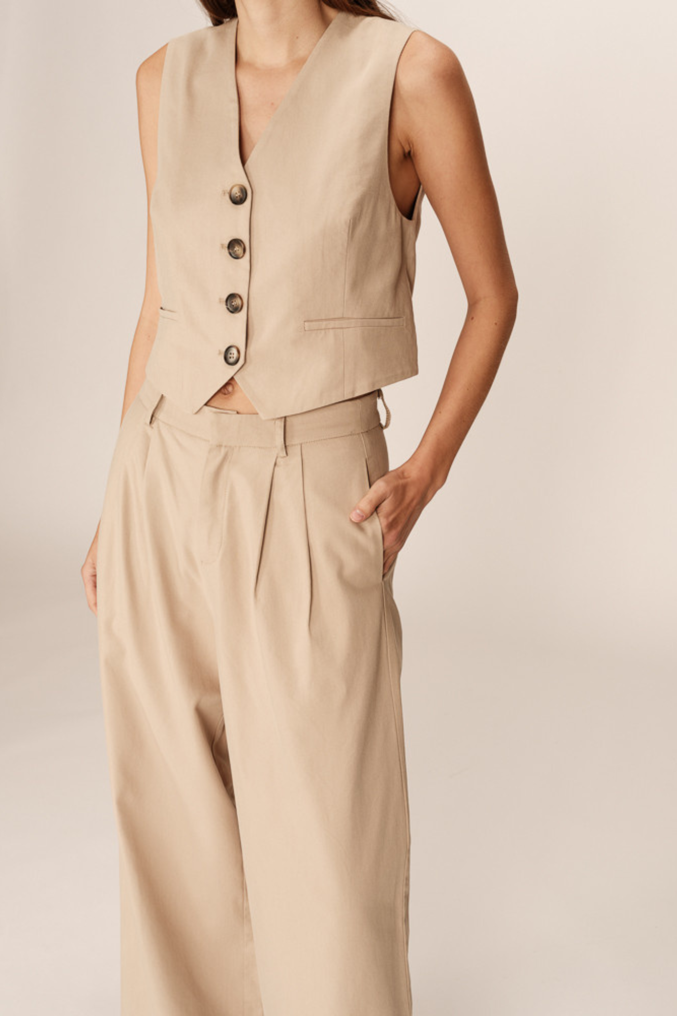 Model wearing the Grace & Mila peter pants in beige. Front view