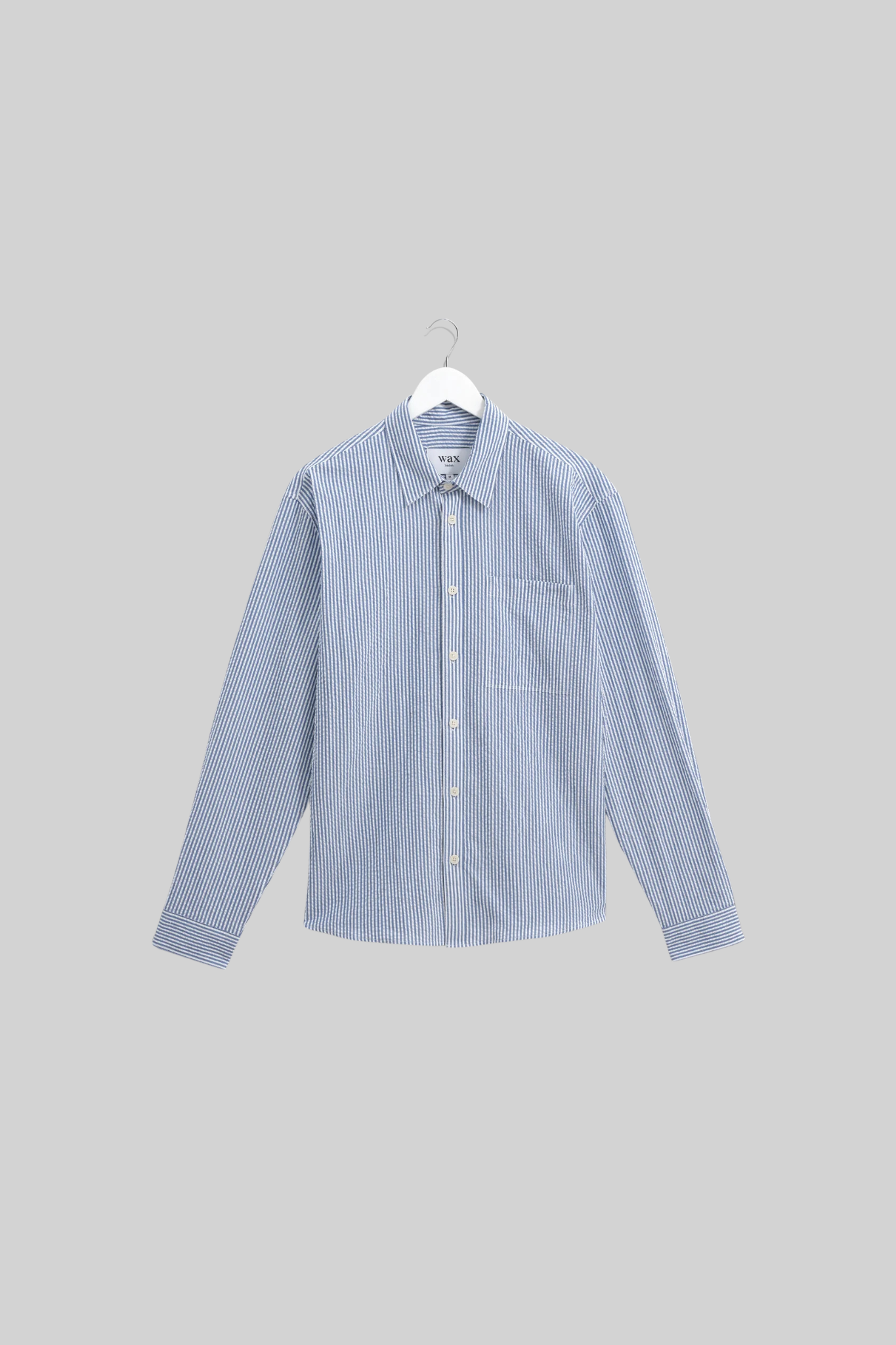 Wax London rove seersucker stripe shirt in blue. Front flatlay view