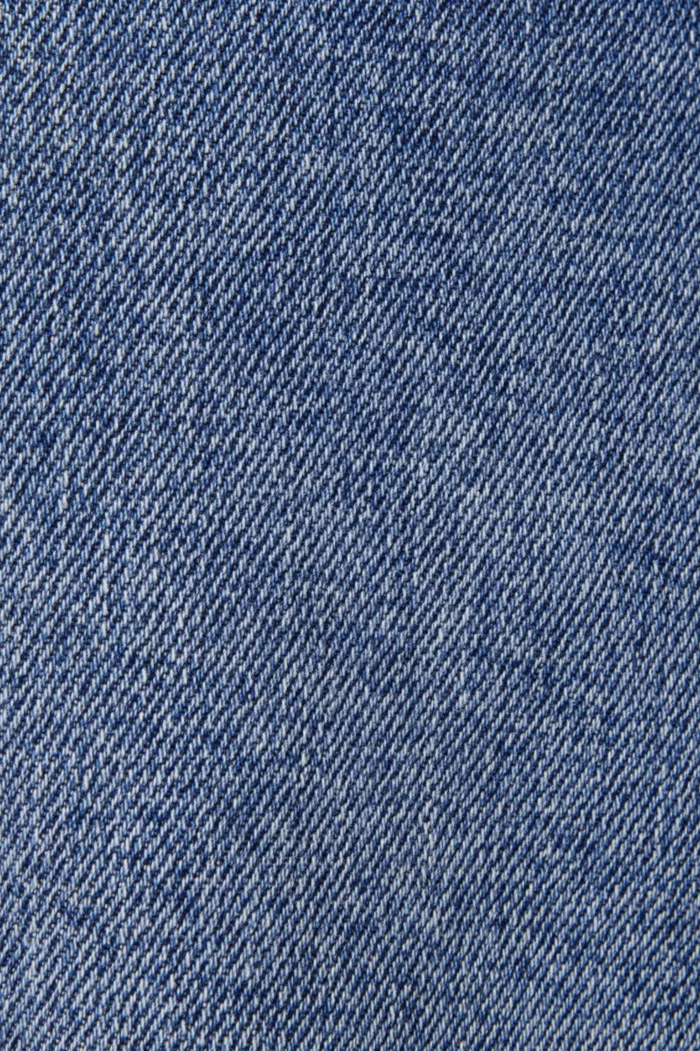 Model wearing the Drykorn hight jeans in blue 3500. Close fabric view