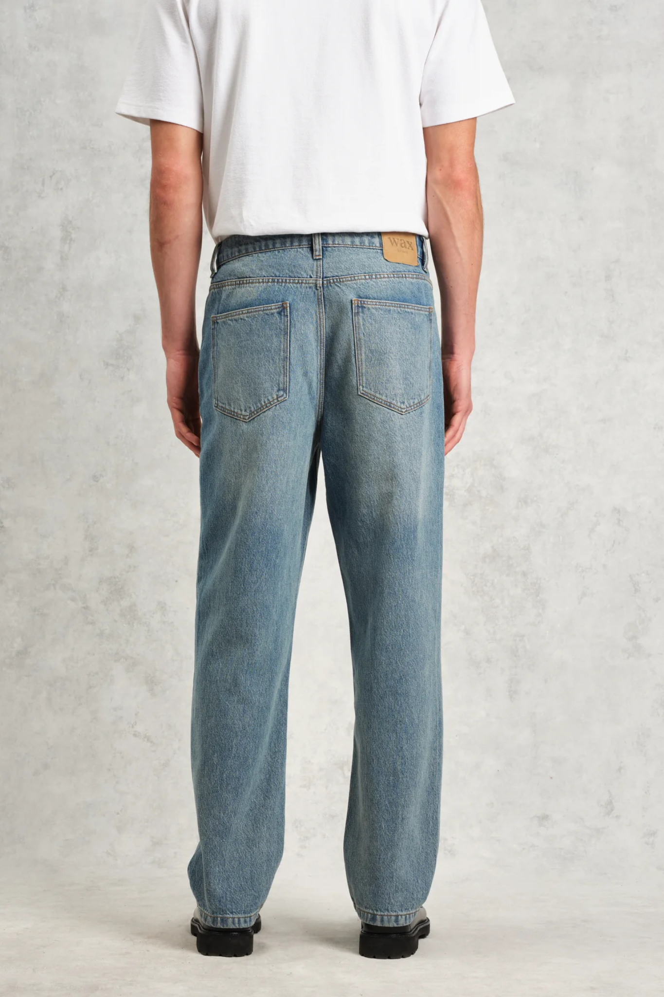 Model wearing the Wax London russel straight fit vintage denim jeans in vintage blue. Back view