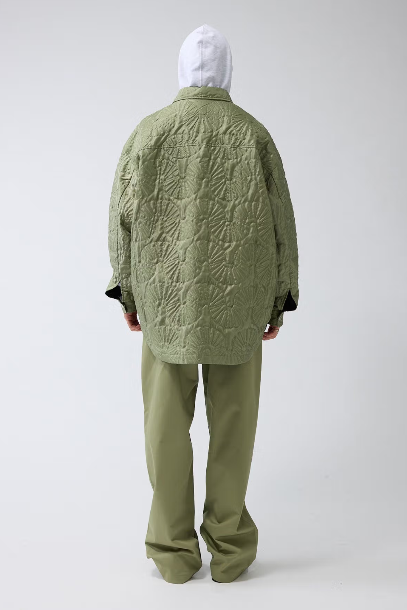 Model wearing the New Amsterdam shell quilted overshirt in green. Back view