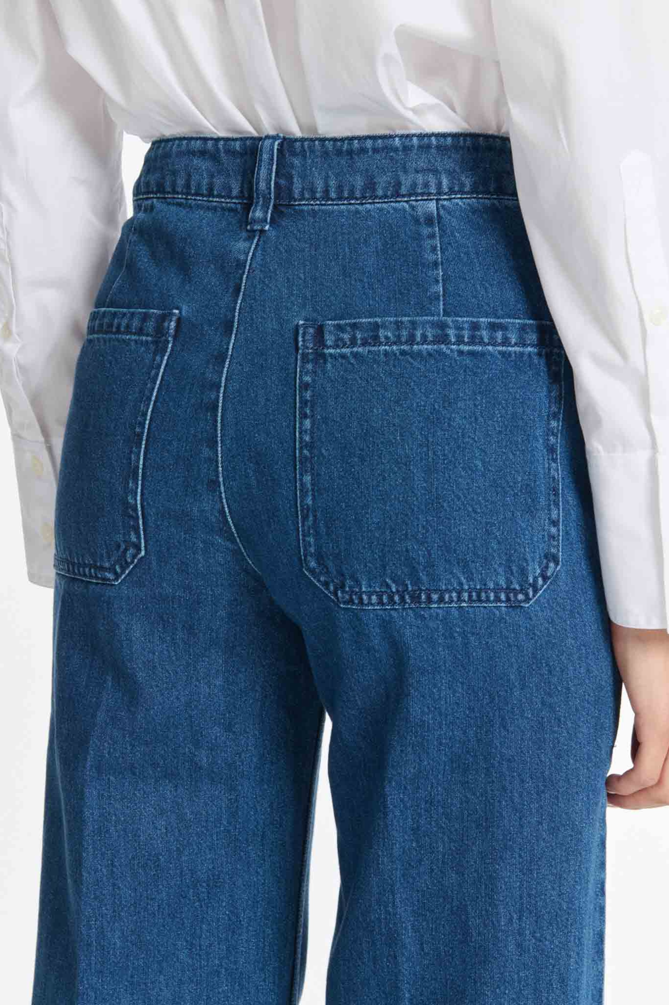 Model wearing the Labdip swann jeans in mid blue. Close back view