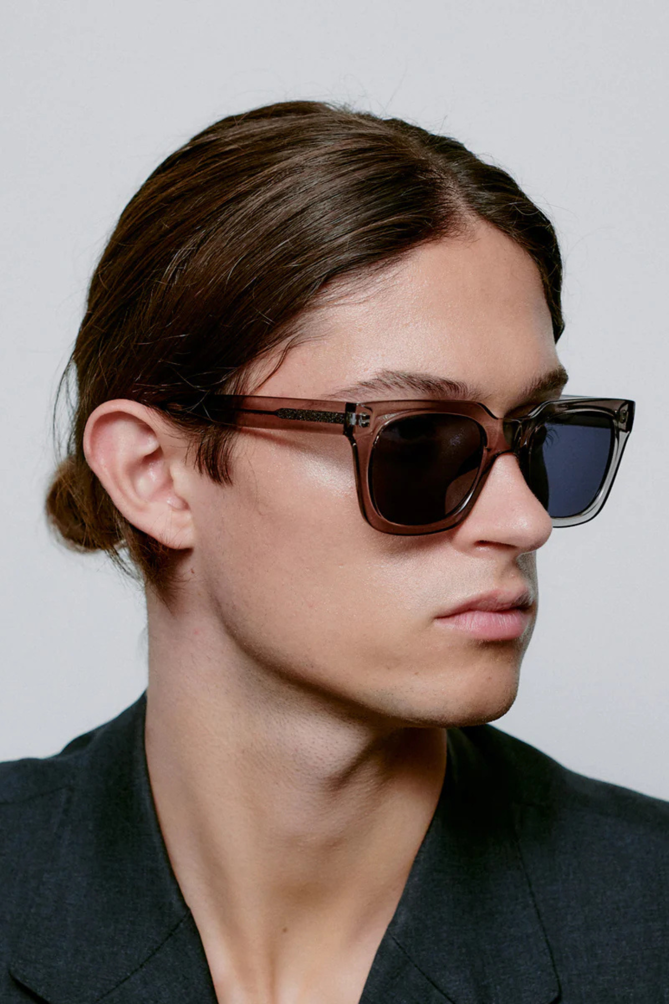 Model wearing the A. Kjaerbede nancy sunglasses in grey transparent. Side view