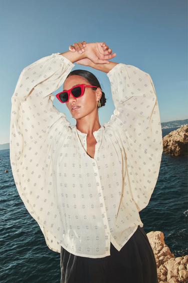 Model wearing the By-Bar becky dali blouse in white and blue. Front view