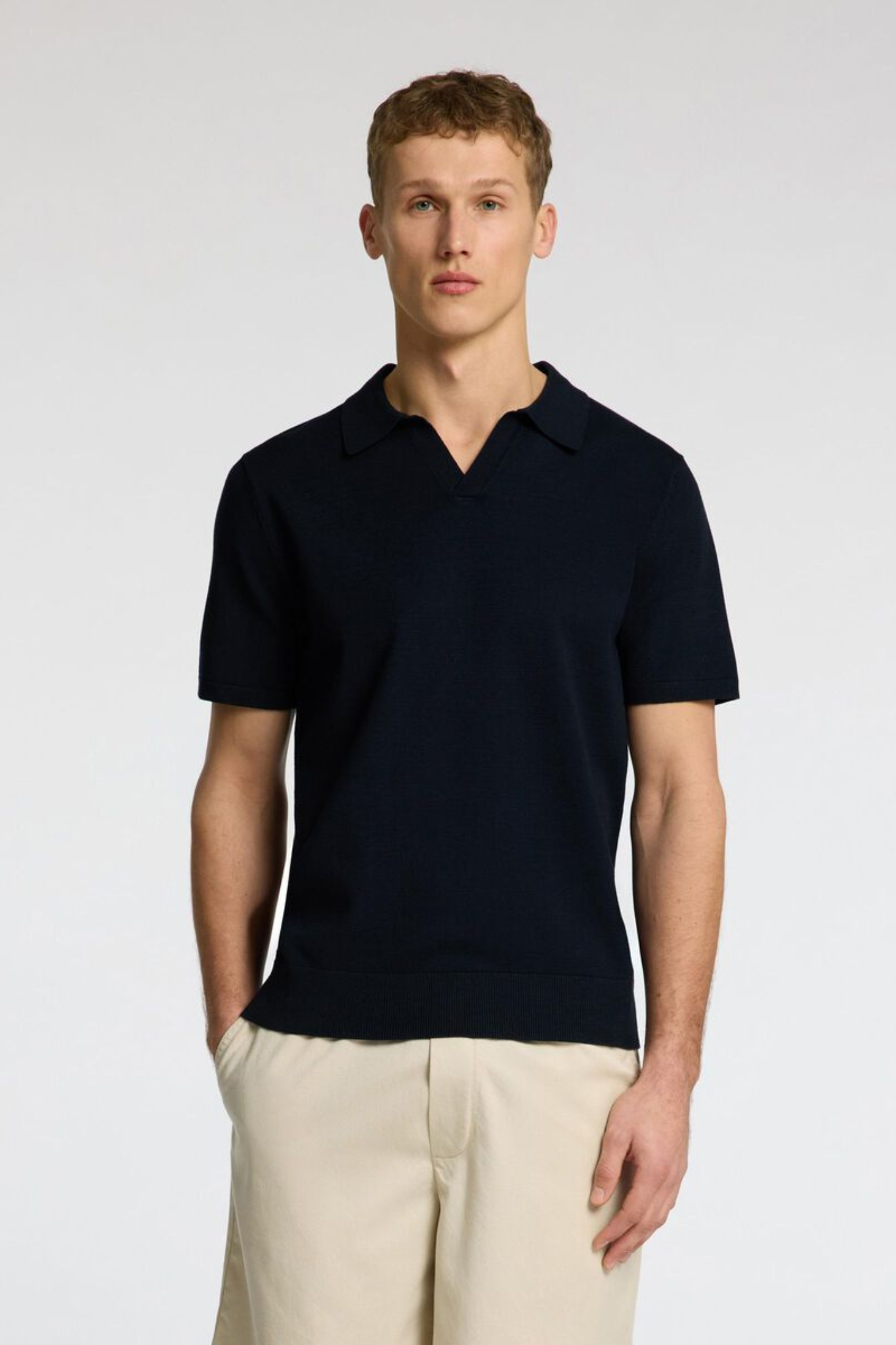 Model wearing the Selected Homme teller knit polo in sky captain. Front view