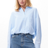 Model wearing the Catwalk Junkie tuck in blouse in blue. Front view