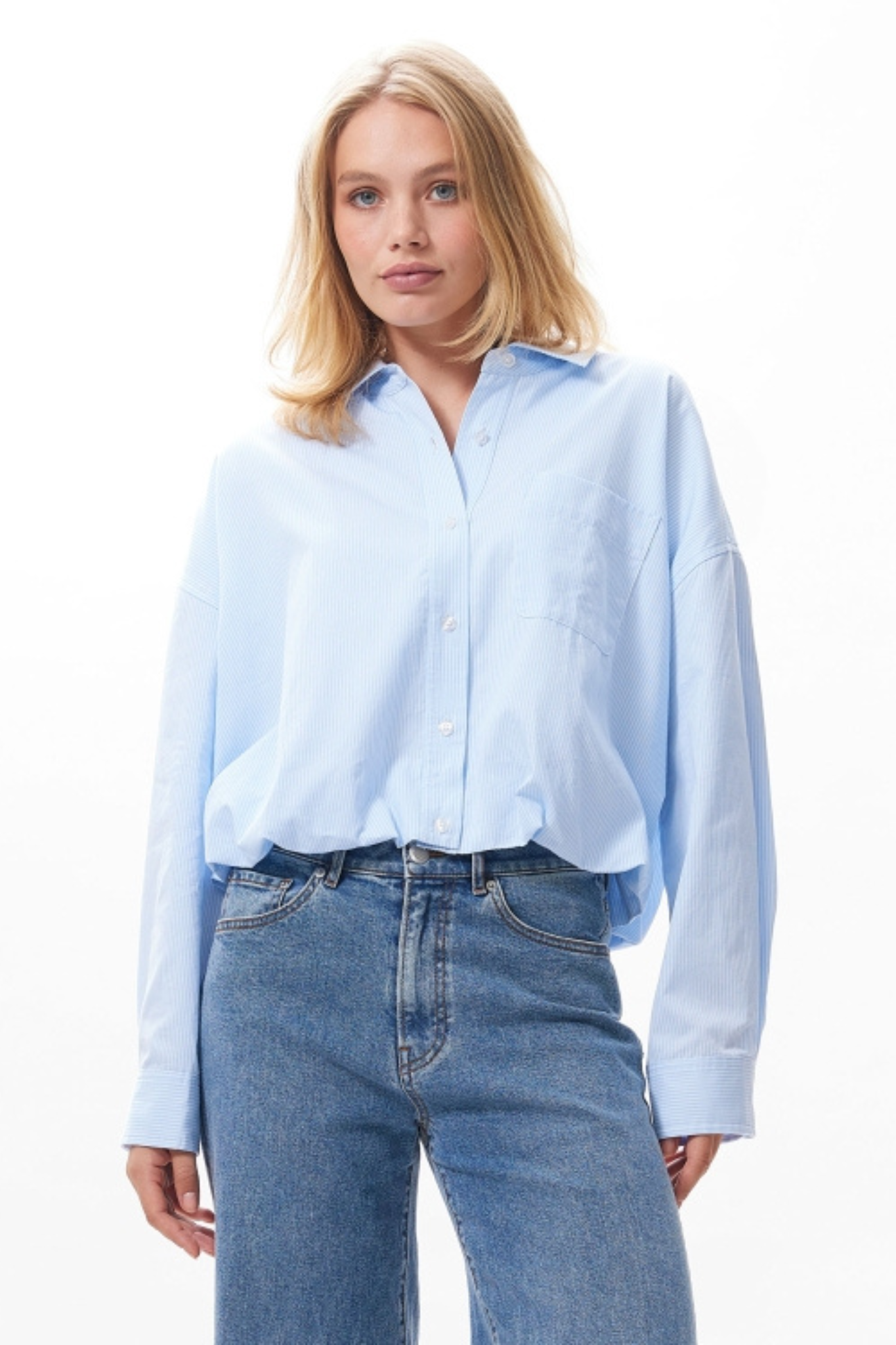 Model wearing the Catwalk Junkie tuck in blouse in blue. Front view