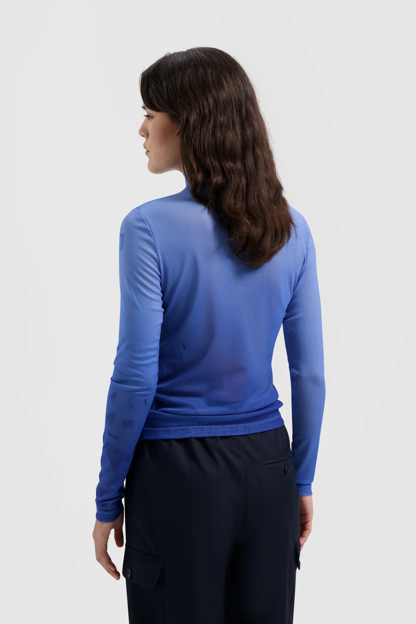 Model wearing the Olaf dandelion mesh top in blue. Back view