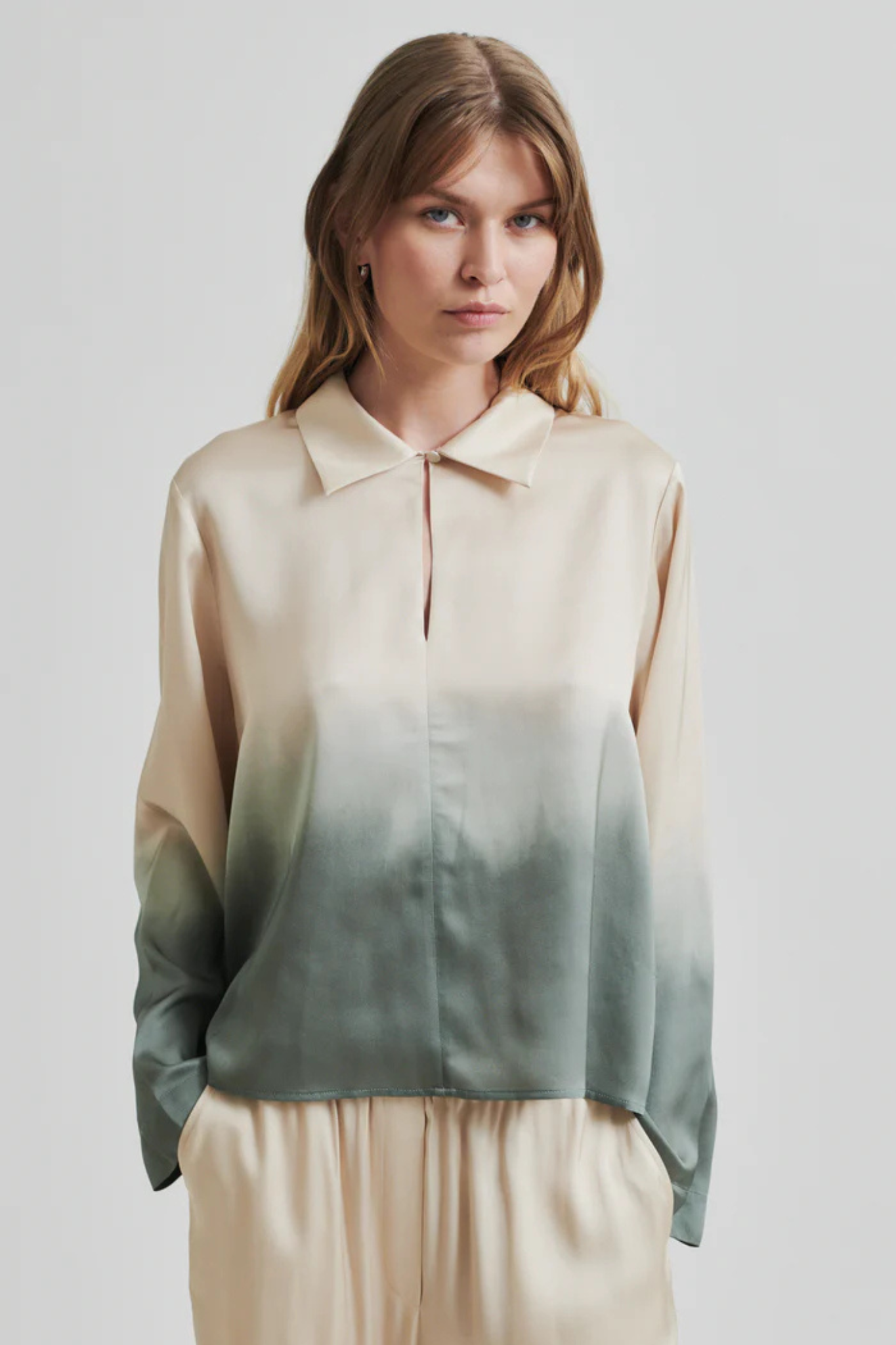 Model wearing the Second Female avora blouse in beige and green. Front view