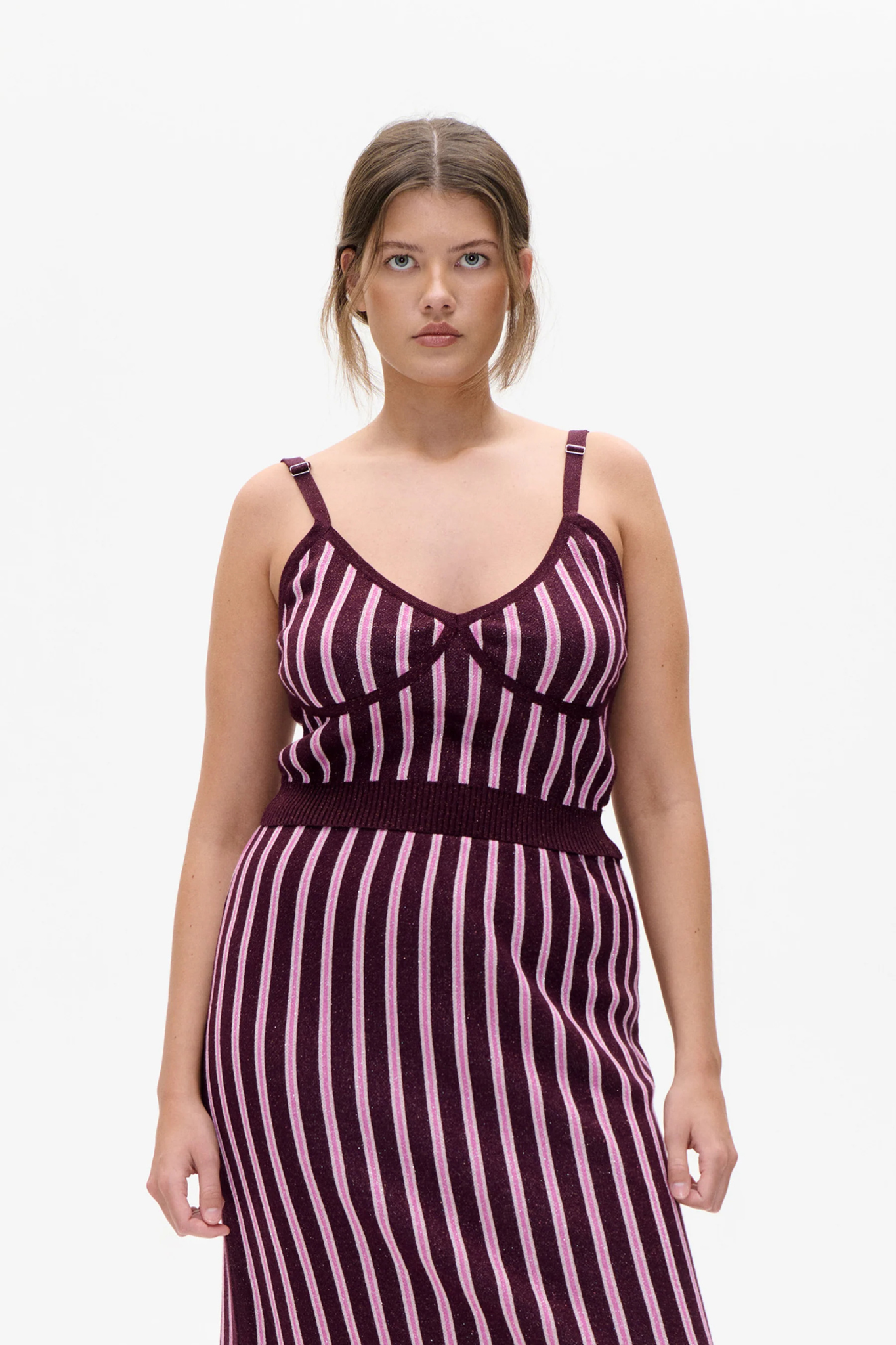 Model wearing the Baum Und Pferdgarten cypre top in purple and pink striped. Front view