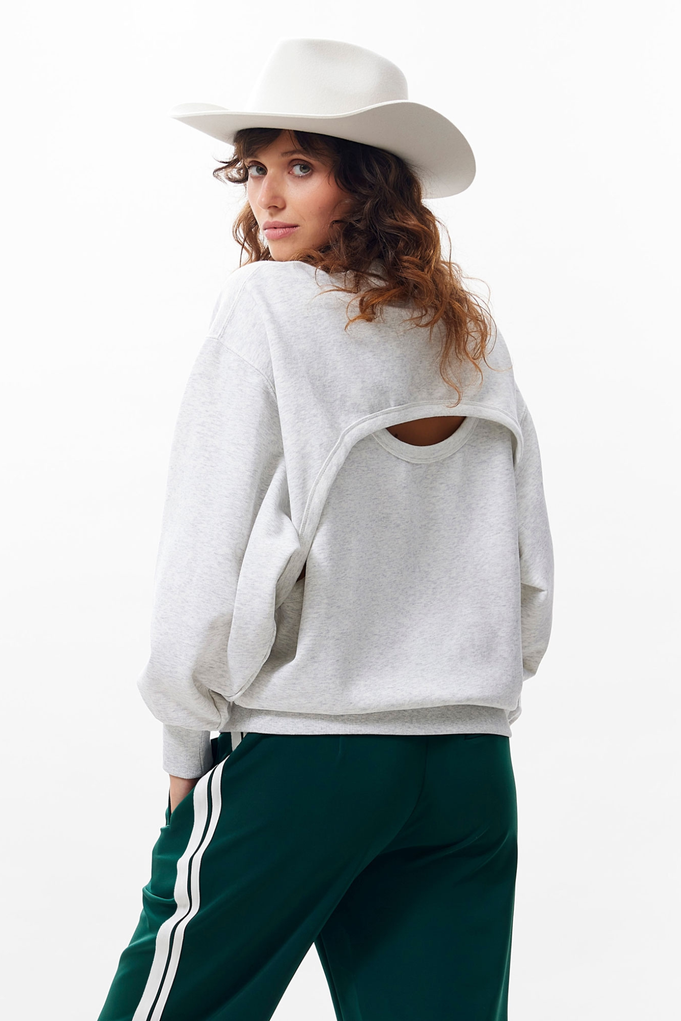 Model wearing the Catwalk Junkie relaxed back detail sweater in light grey melange. Back view