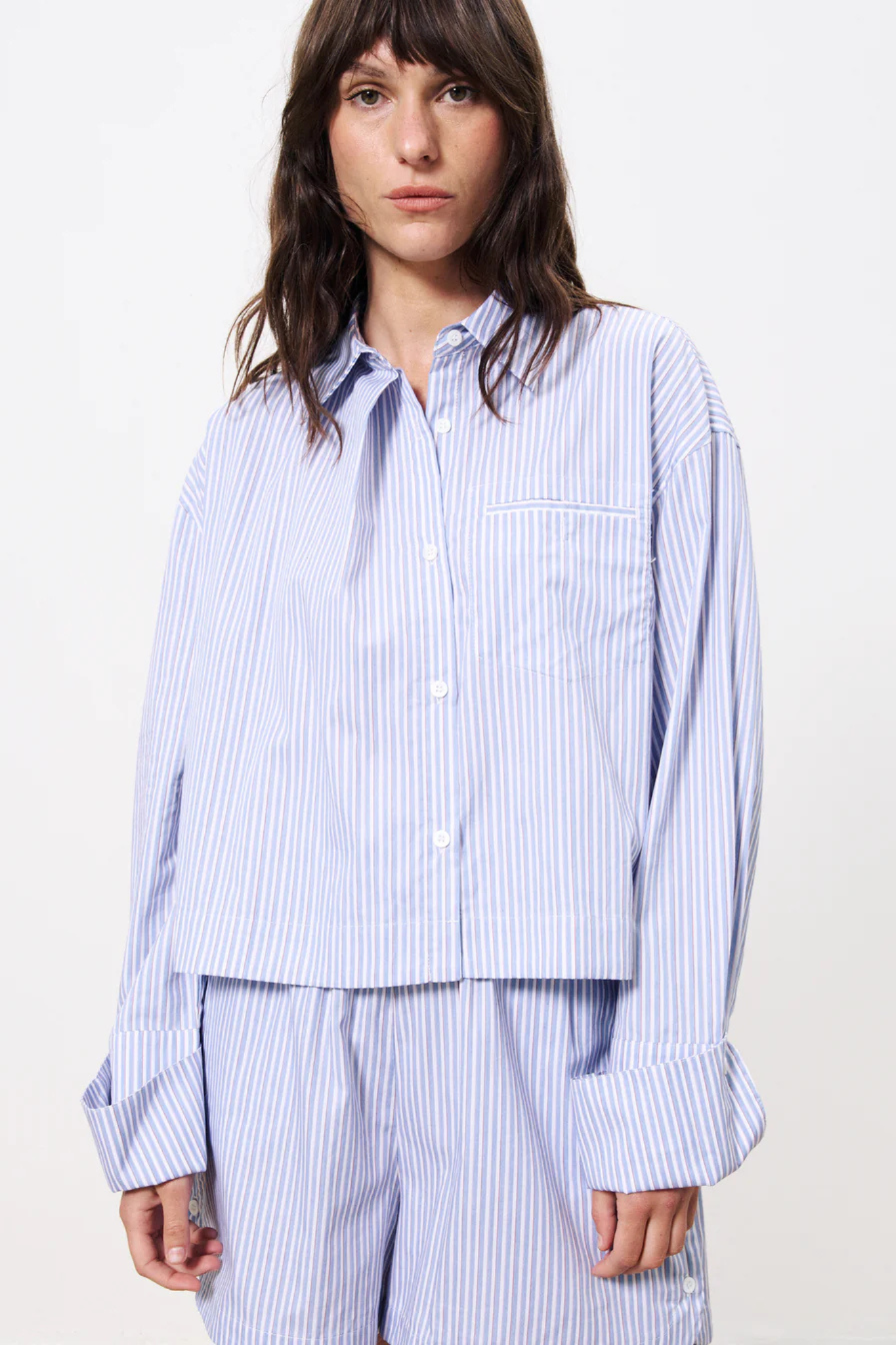 Model wearing the FRNCH naela shirt in striped blue and white. Front view