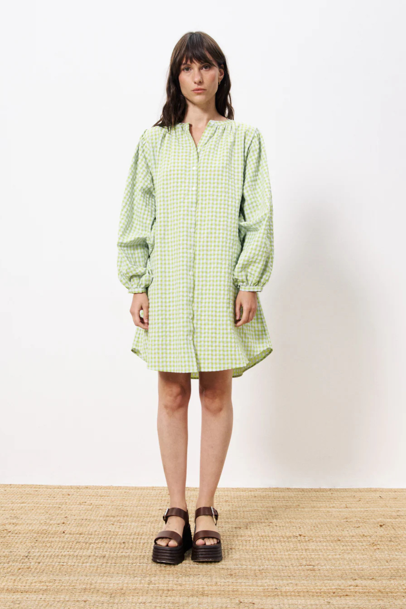 Model wearing the FRNCH noely dress in green checked. Front view