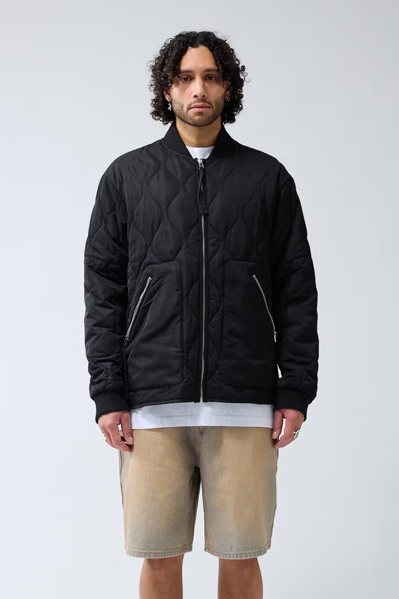 Model wearing the New Amsterdam quilted padded jacket in black. Front view