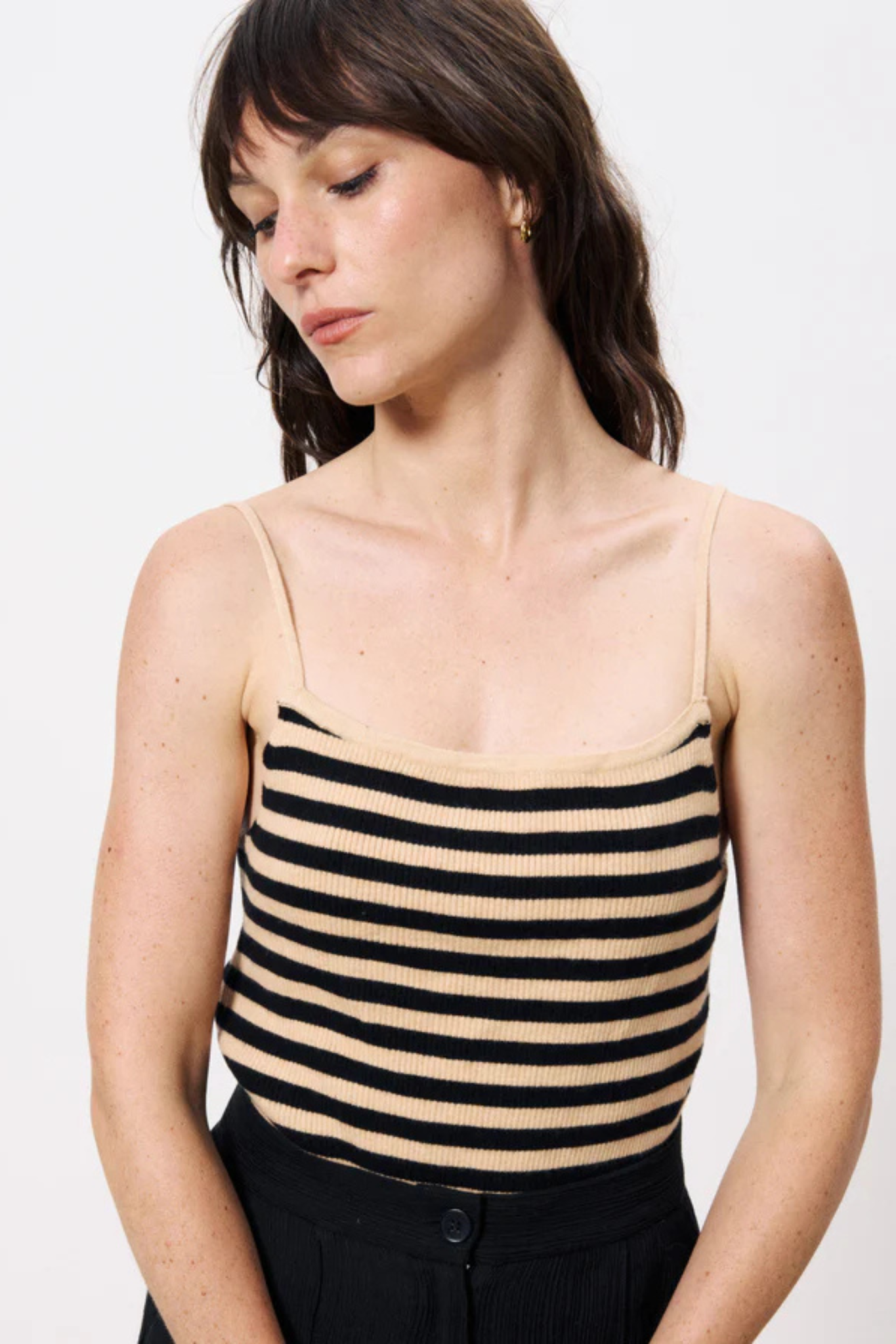 Model wearing the FRNCH ninette tank top in striped black and beige. Front view