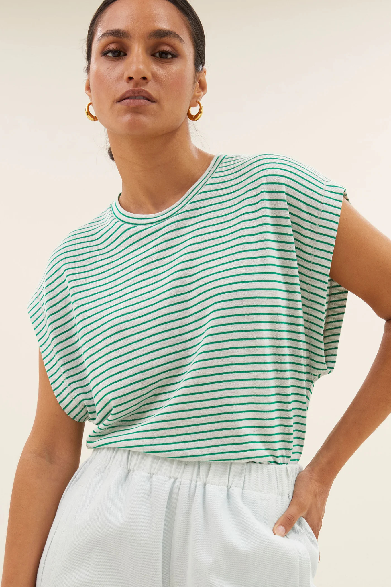 Model wearing the By-Bar mason small stripe top in white and green striped. Front view