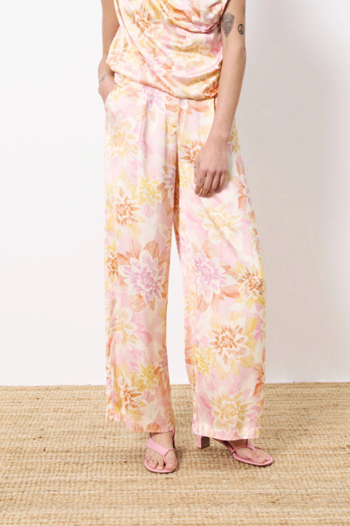 Model wearing the FRNCH philo pants in flower pattern. Front view