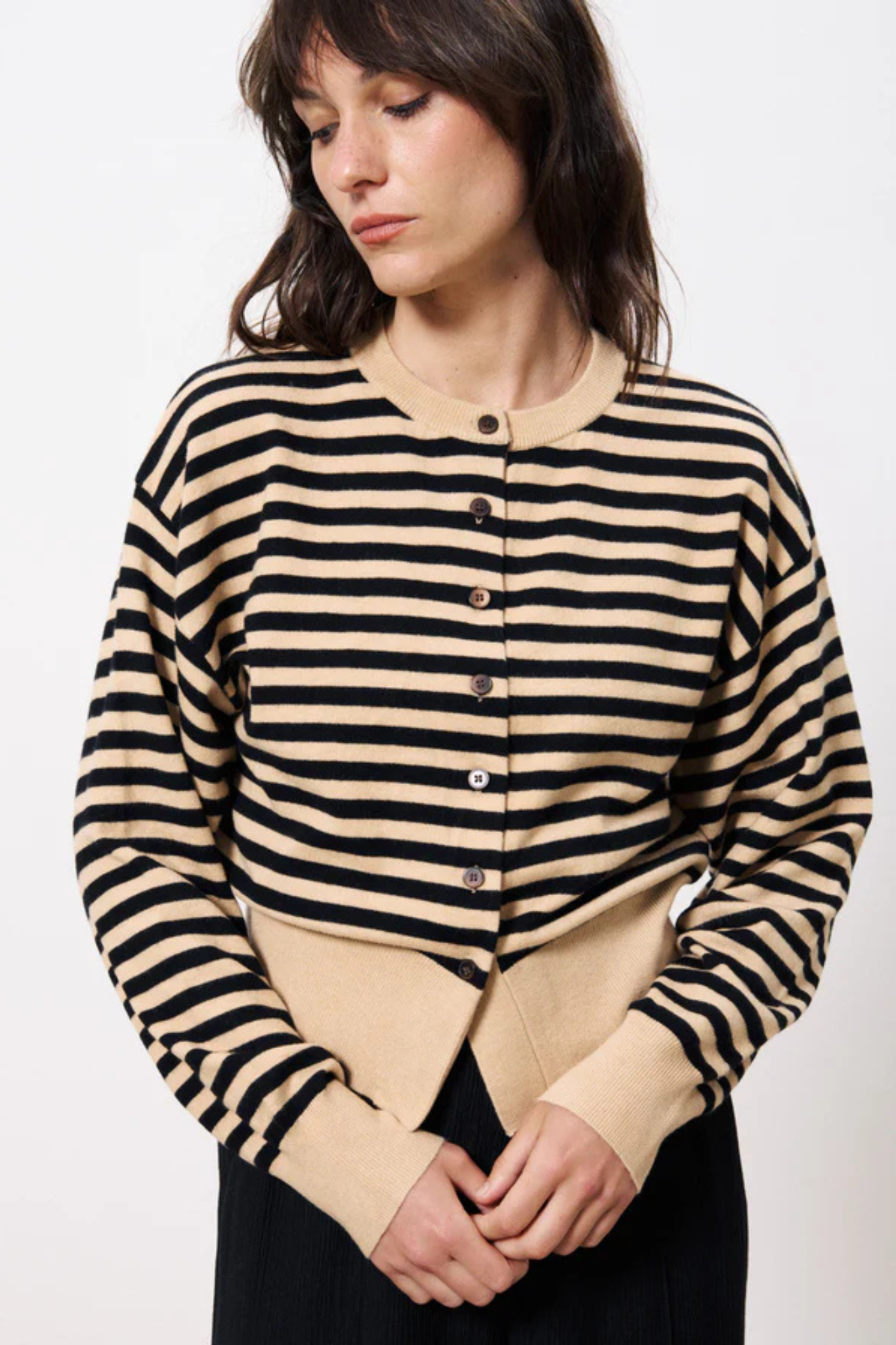 Model wearing the FRNCH noumea cardigan striped in black and beige. Front view