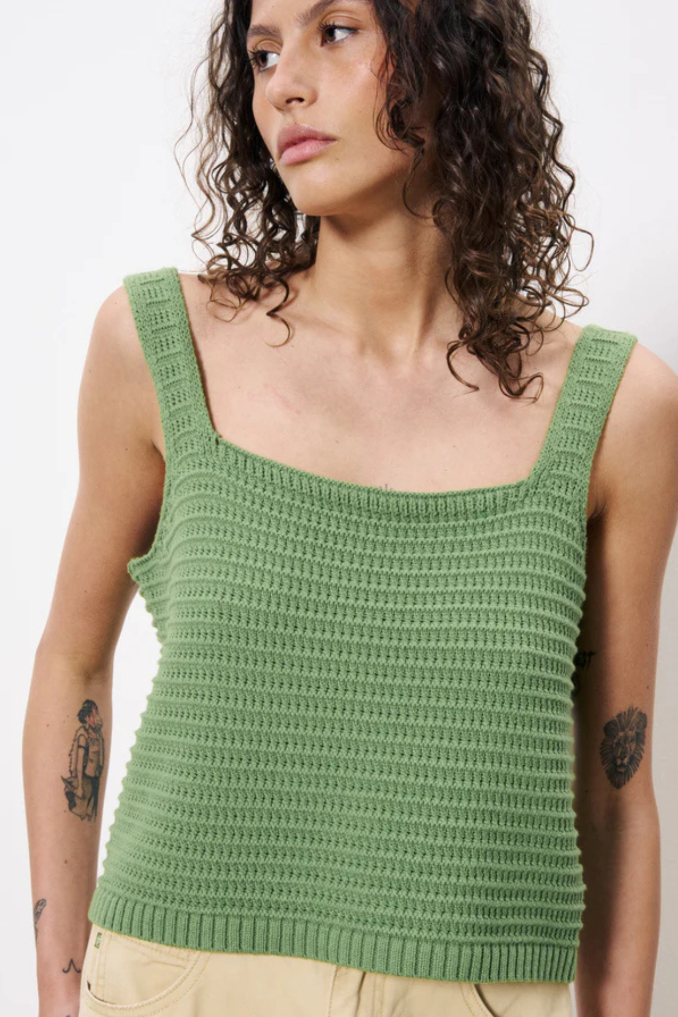 Model wearing the FRNCH celuta top in green. Front view