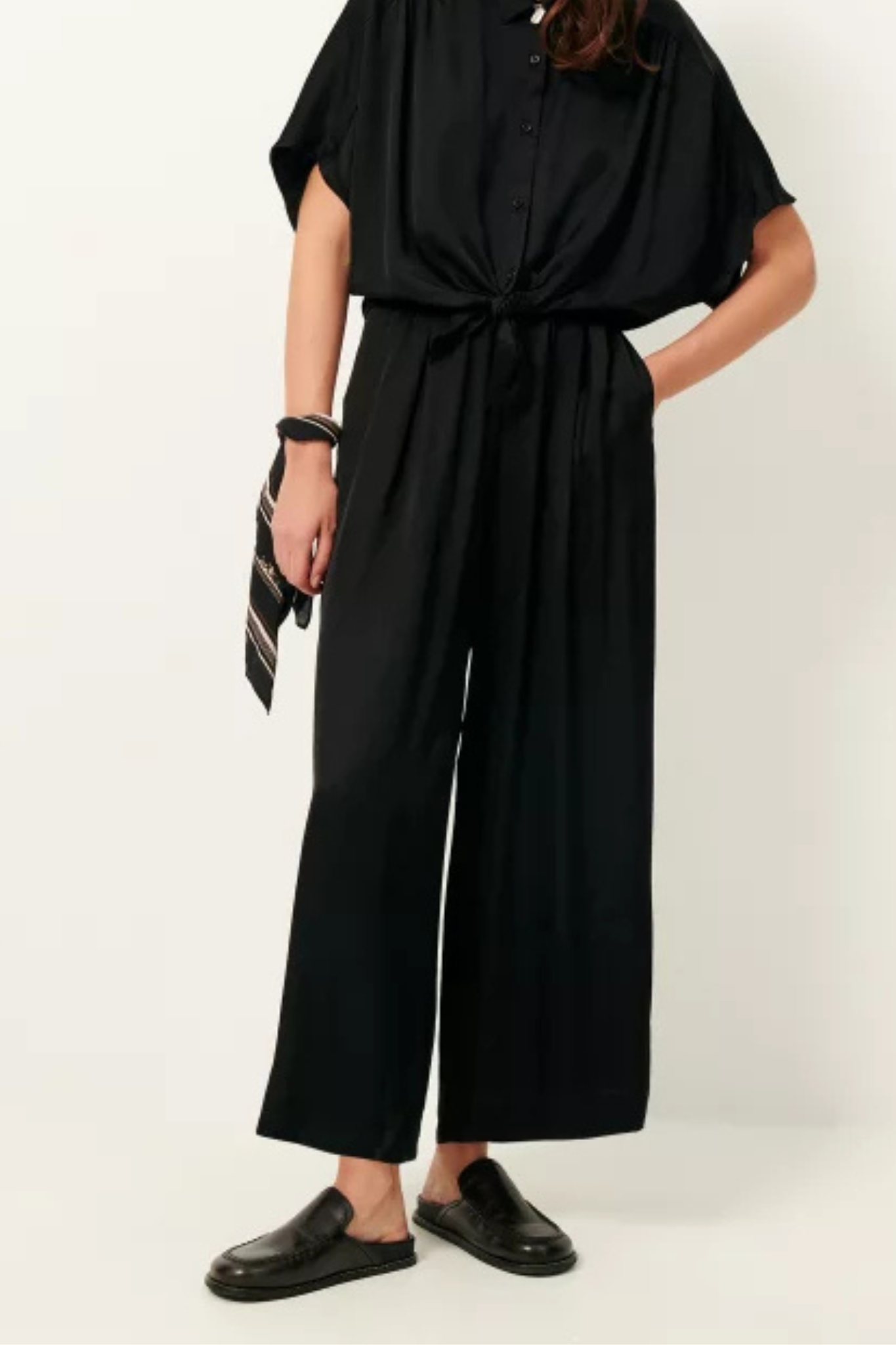 Model wearing the Sessun isla night wide leg elastic pants in black. Front view