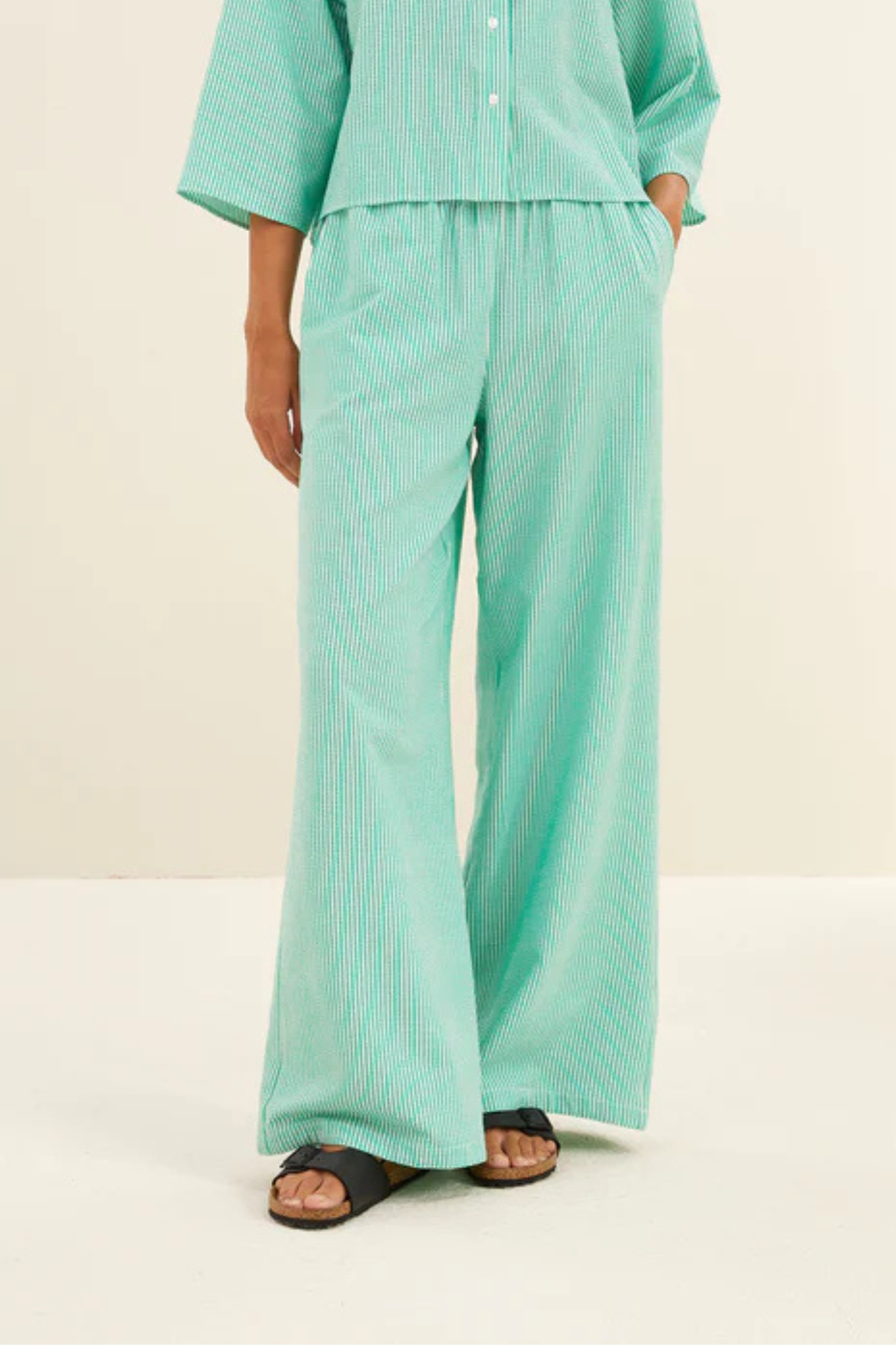 Model wearing the By-Bar randy pants in striped green. Front view