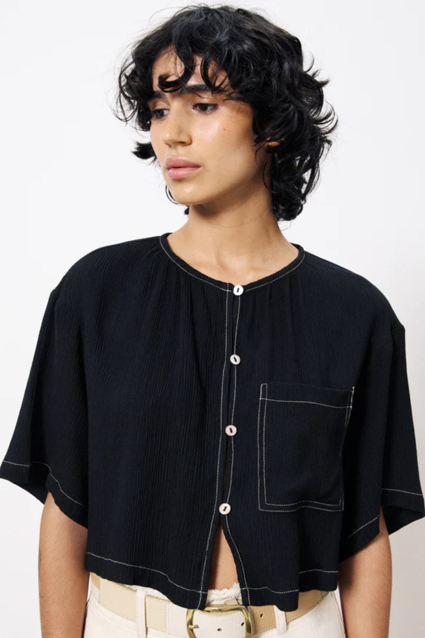 Model wearing the FRNCH casimire top in black. Front view