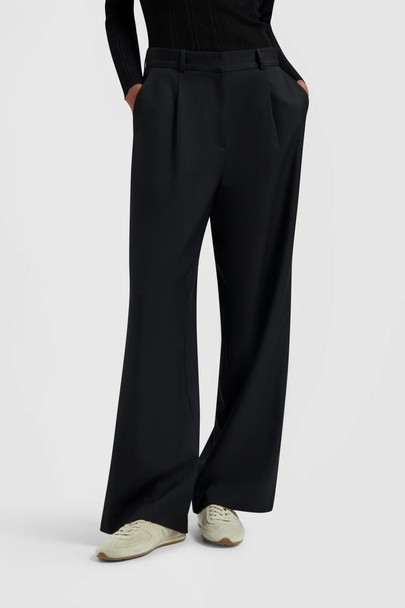 Model wearing the Olaf tailored trousers in black. Front view