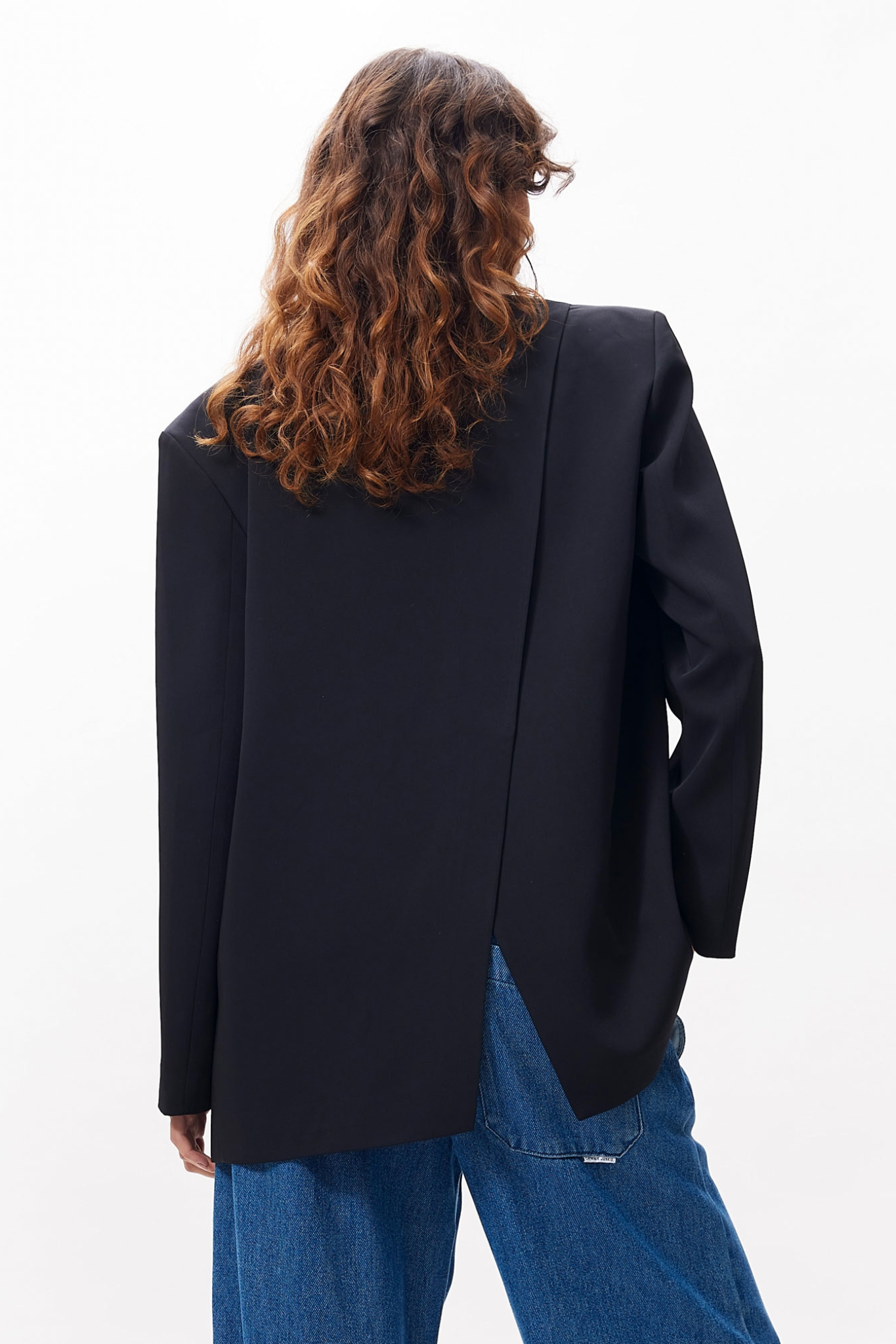 Model wearing the Catwalk Junkie relaxed back detail blazer in black. Back view