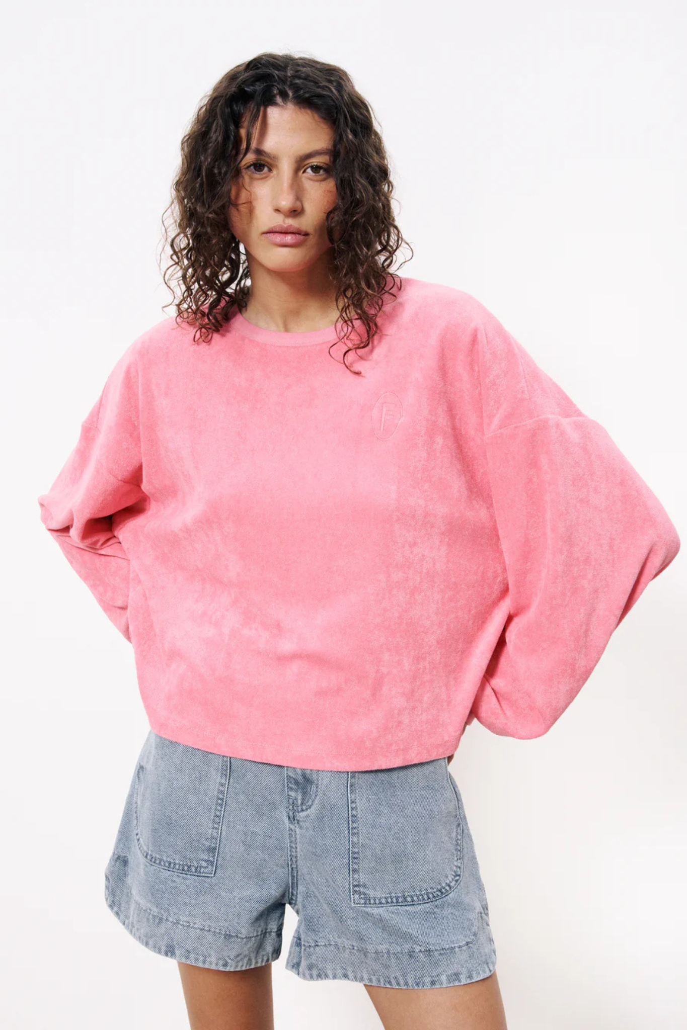 Model wearing the FRNCH calliste sweatshirt in pink. Front view