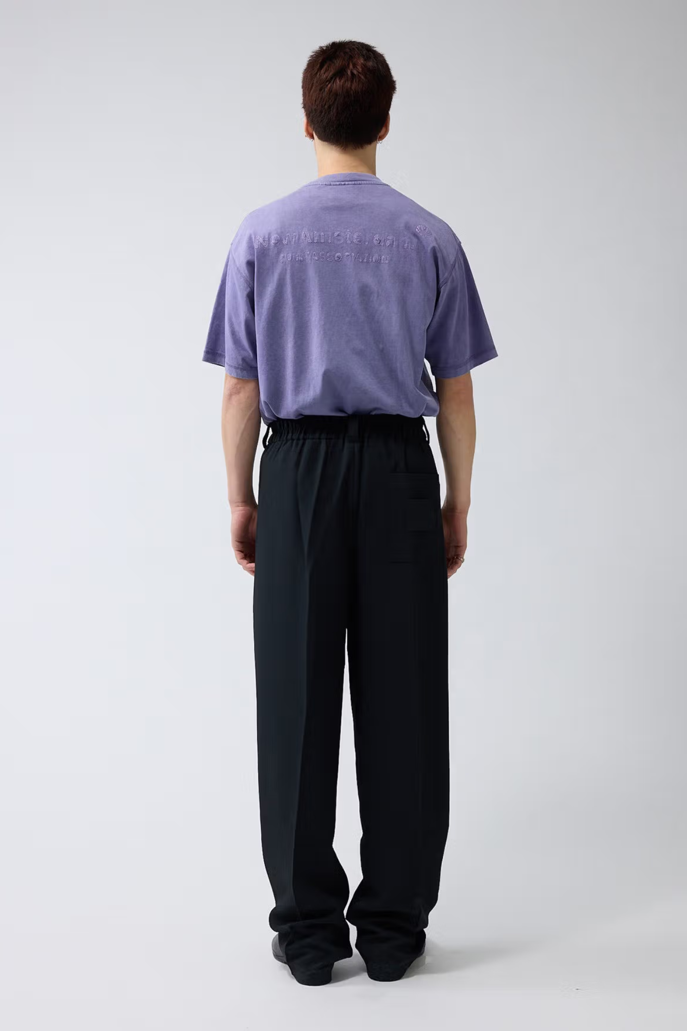 Model wearing the black New Amsterdam wool trousers. Back view