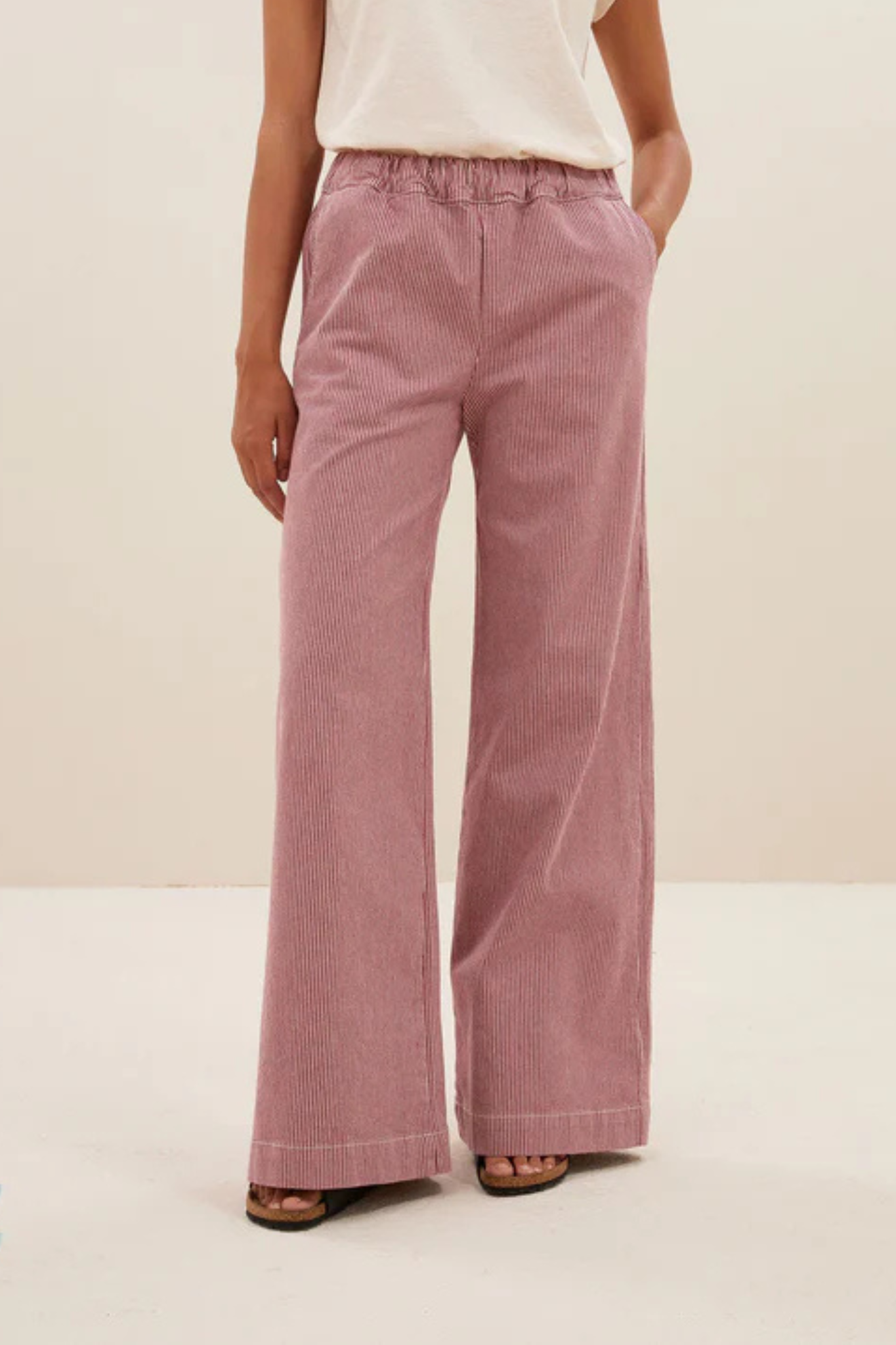 Model wearing the By-Bar Neal striped pants in pink and white. Front view