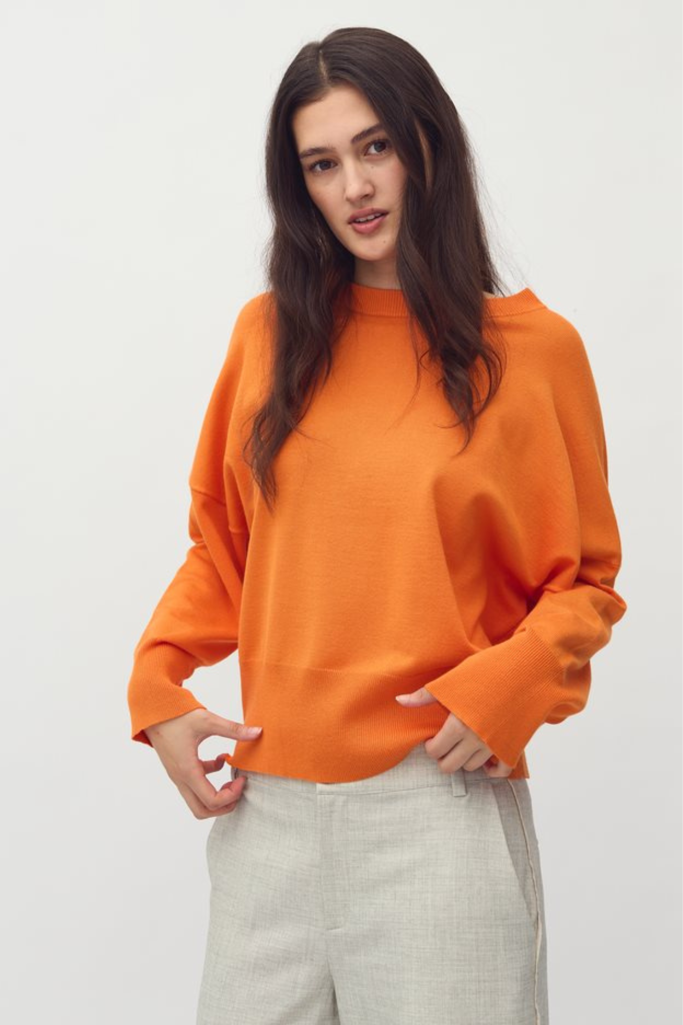 Model wearing the MBYM bravani gillian knit in orange peel. Front view