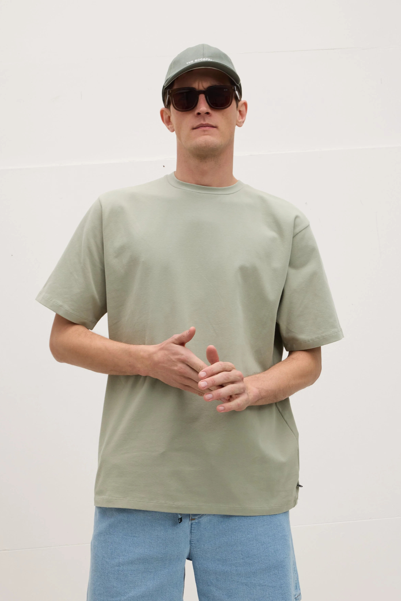 Model wearing the Goodpeople ted t-shirt in faded green. Front view