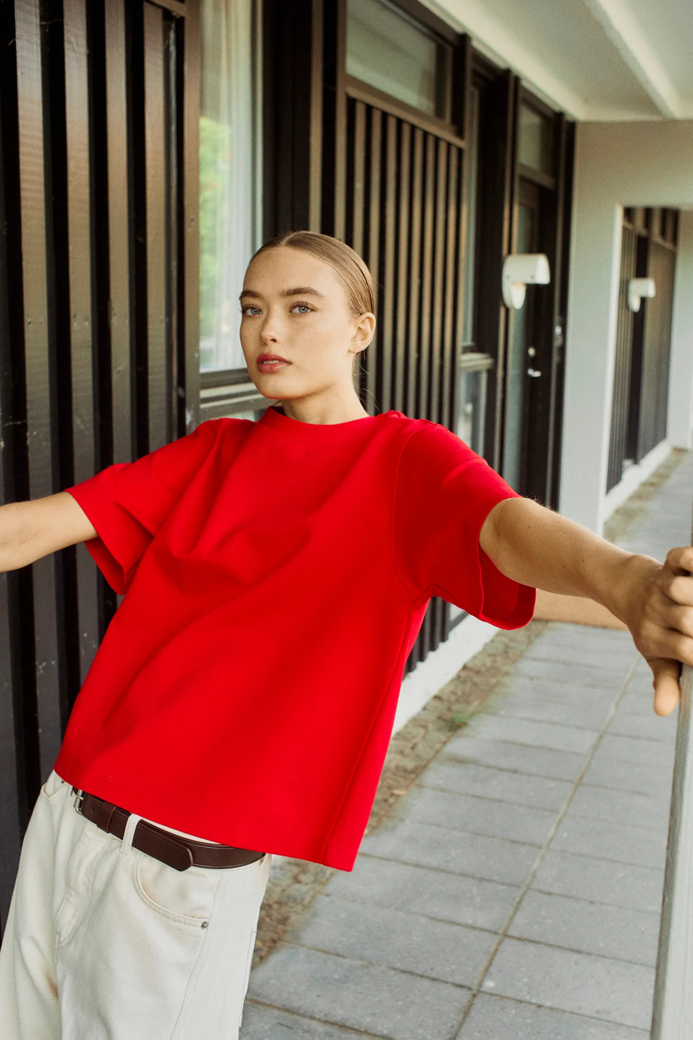 Model wearing the Norr orah tee in bright red. Front view