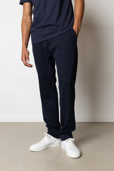 Model wearing the Clean Cut Copenhagen jersey pants in navy. Front view