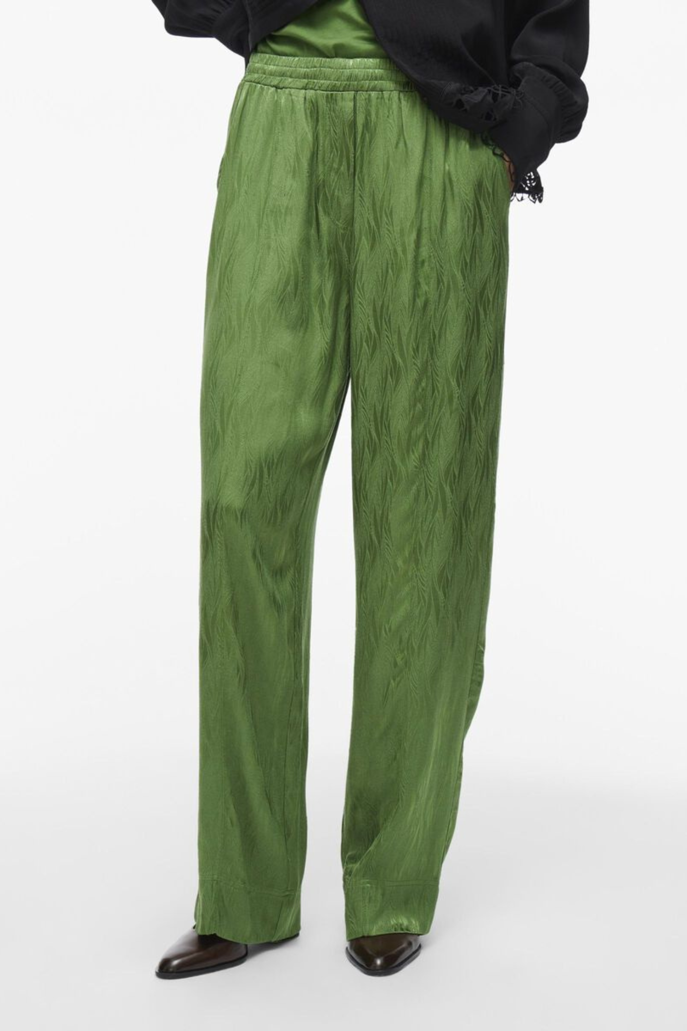 Model wearing the Rouge Edit artichoke green Roumarta trousers. Front view