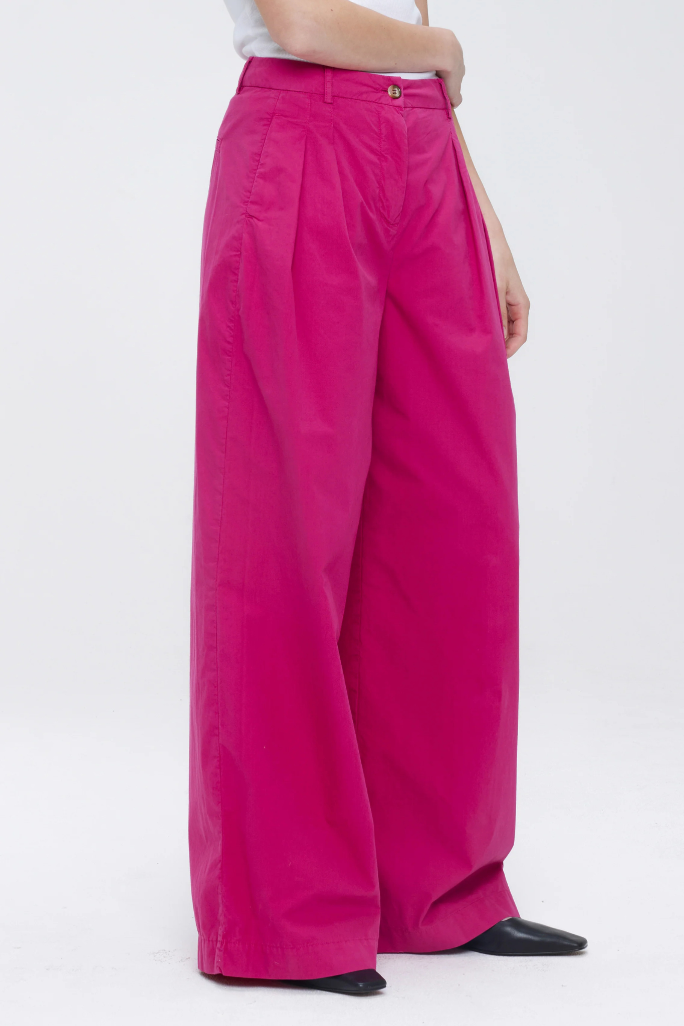 Model wearing the Our Sister Pansmokeyc pants in fuchsia. Front view