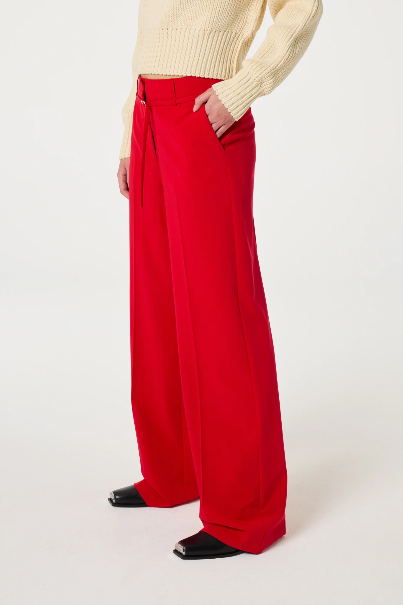 Model wearing the Fabienne Chapot Nelsan pants in red. Side view