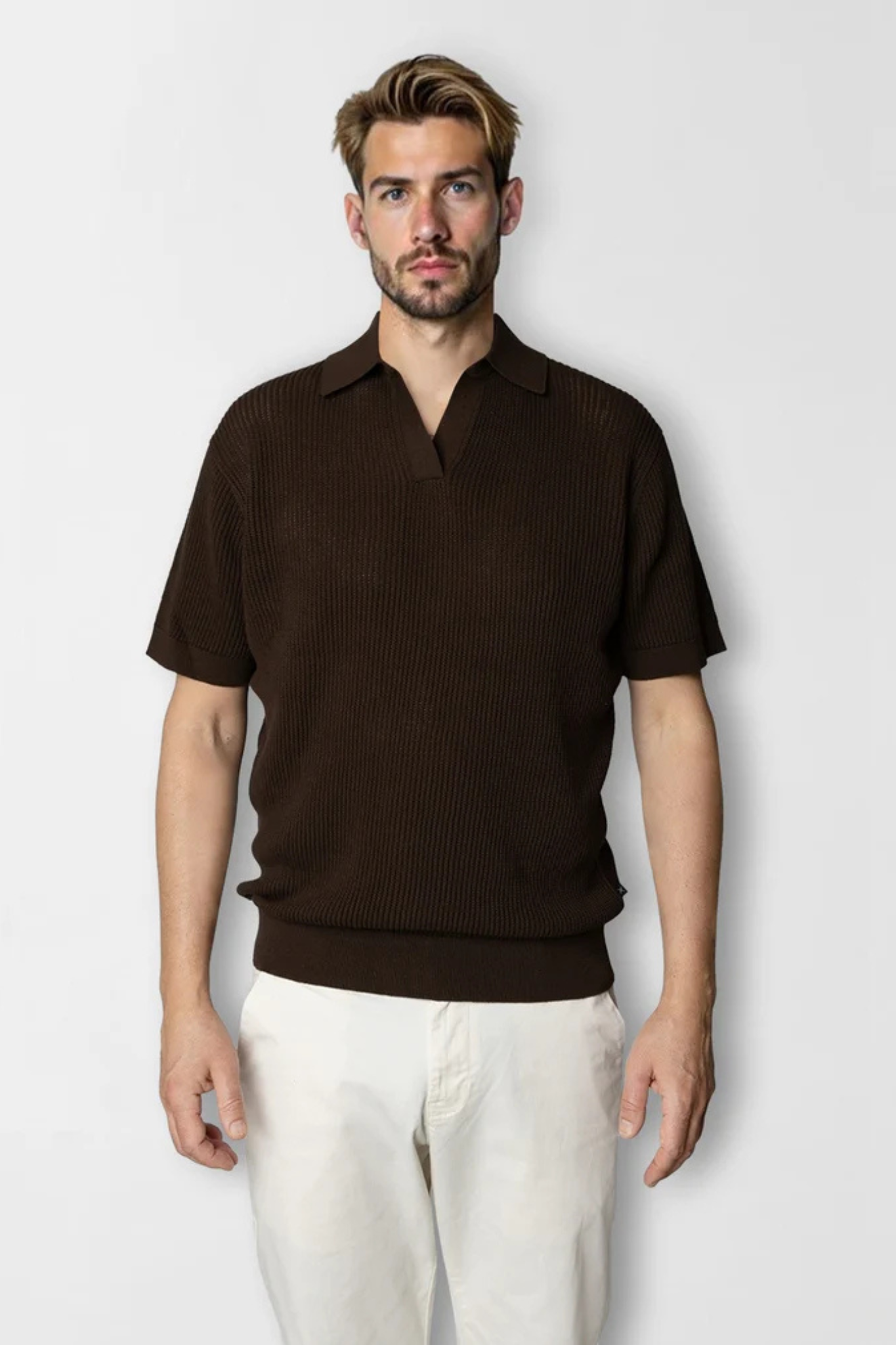 Model wearing the Clean Cut Copenhagen  oliver knitted polo in dark brown. Front view