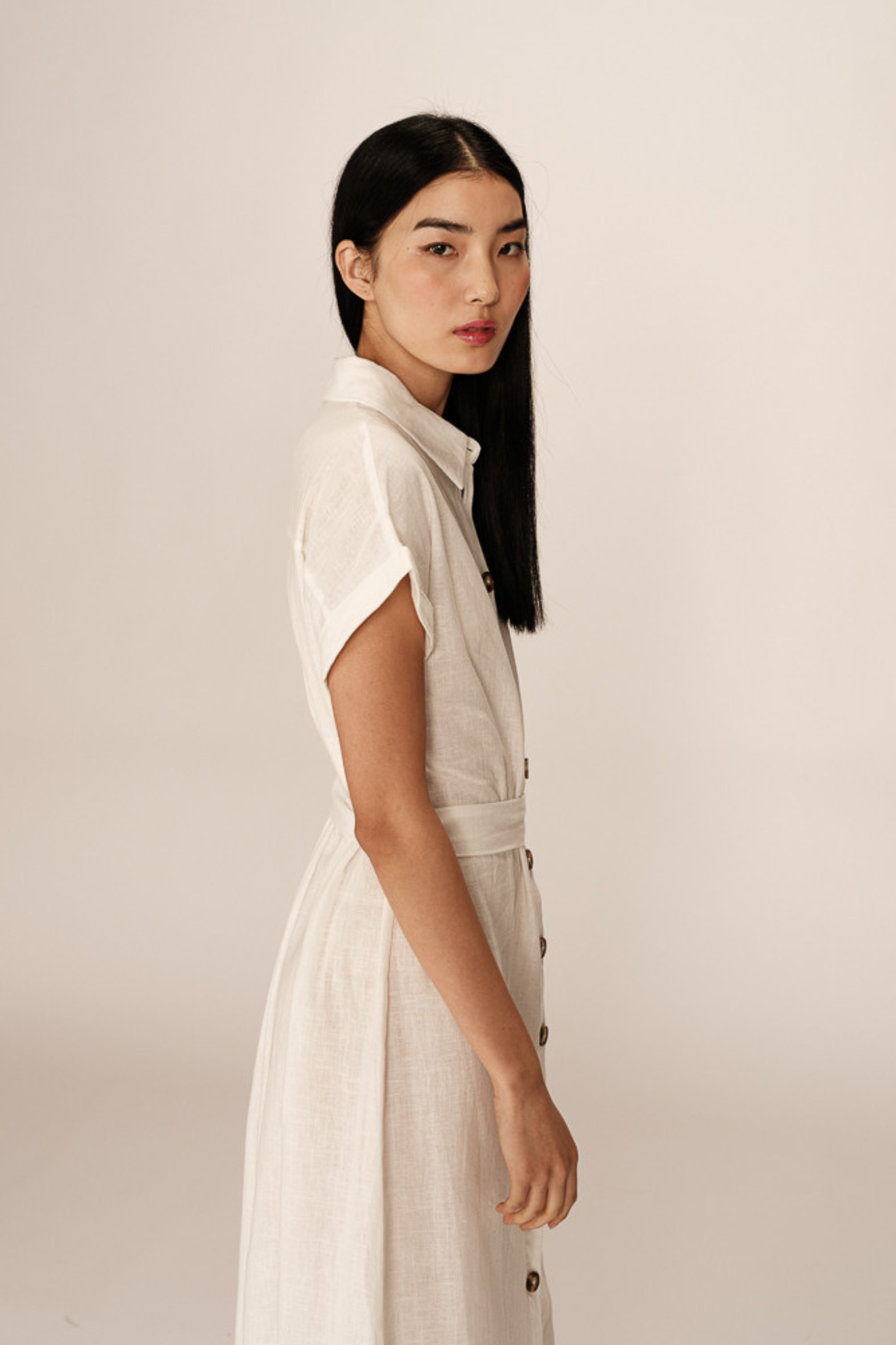 Model wearing the Grace & Milla prudence dress in white. Side view