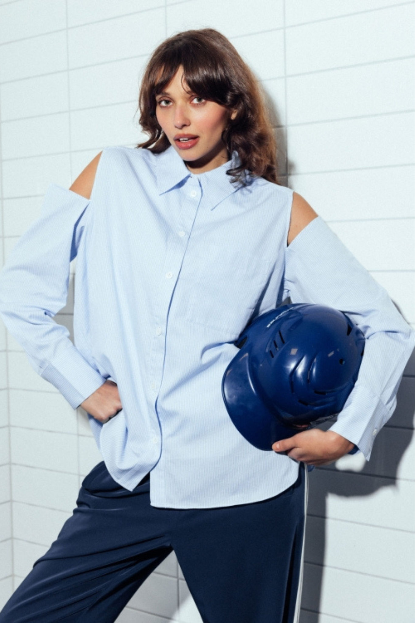 Model wearing the Catwalk Junkie open shoulder blouse in blue. Front view