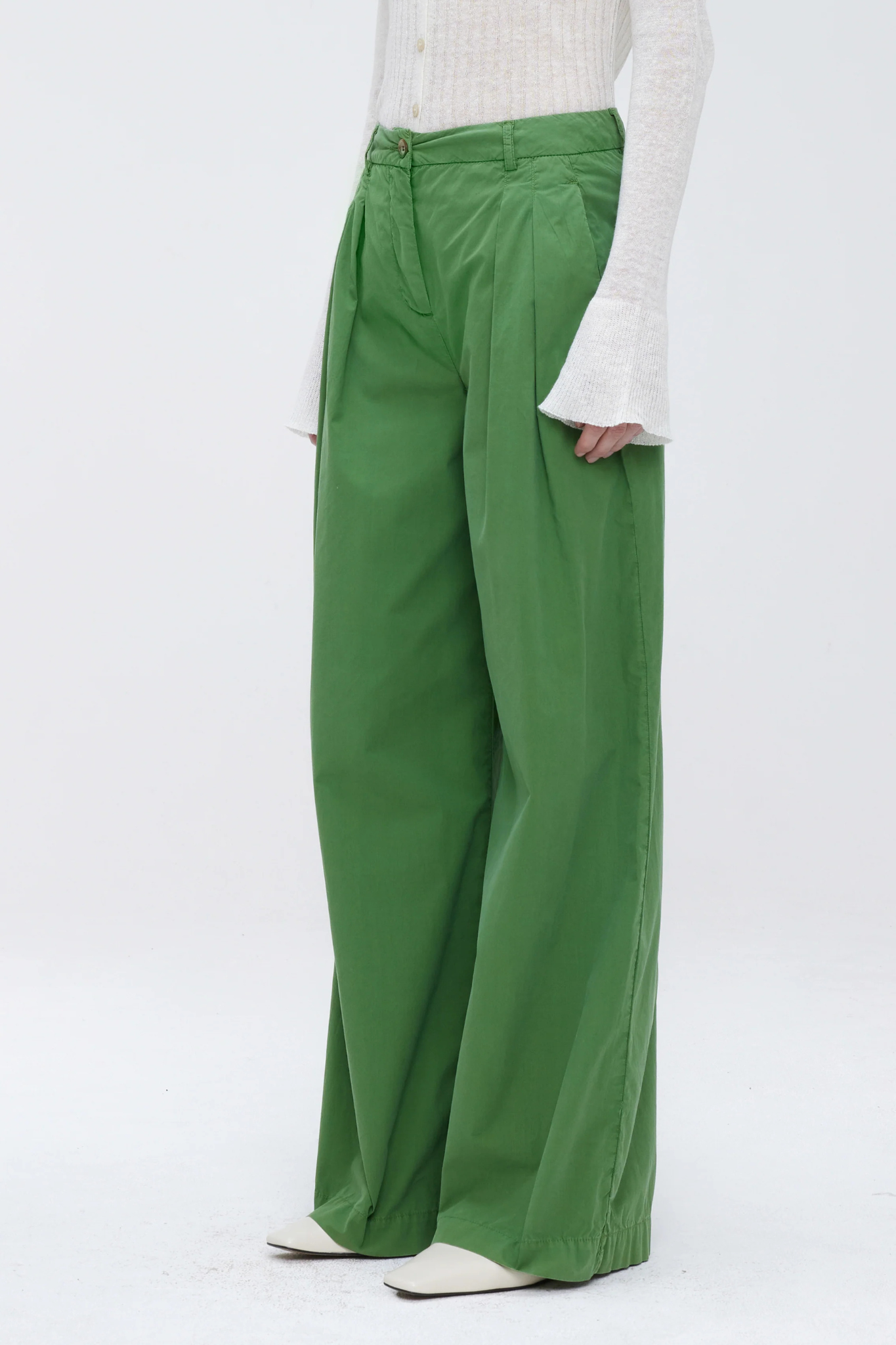 Model wearing the Our Sister Pansmokeyc pants in green. Front view