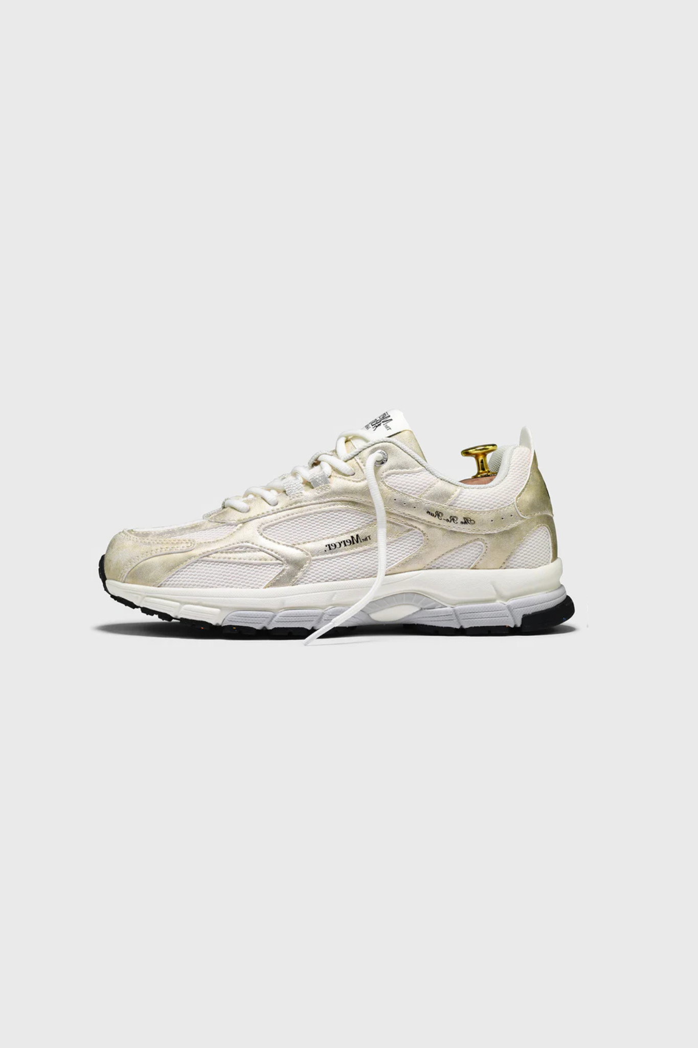 Mercer re-run metallic sneakers in gold. Side view