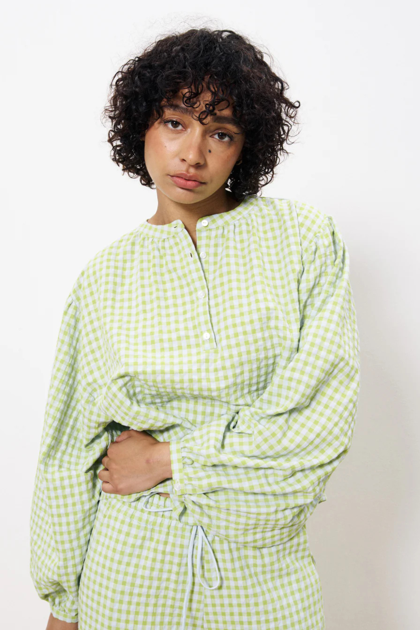 Model wearing the FRNCH noura blouse in green checked. Front view