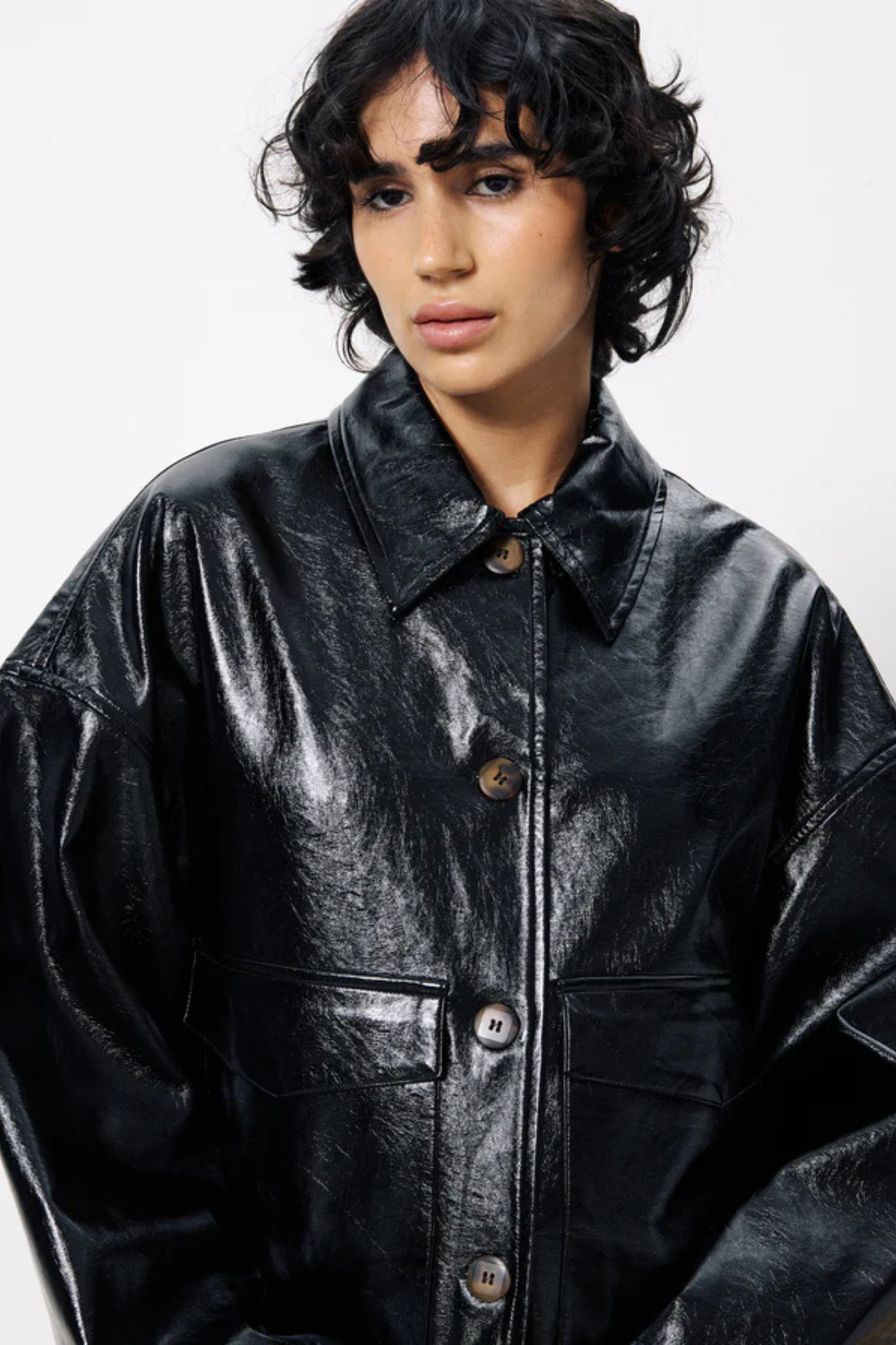 Model wearing the FRNCH carmelie jacket in black. Front view