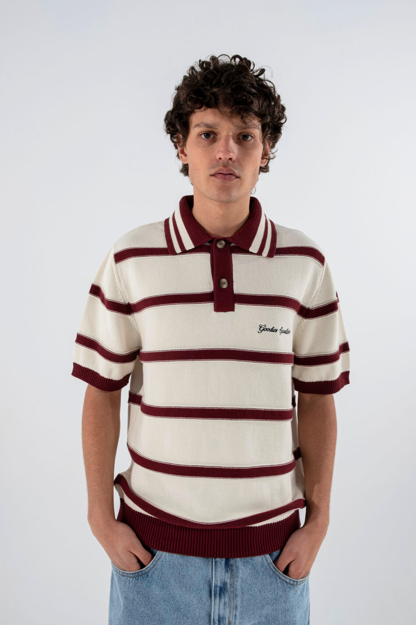 Model wearing Goodies Sportive plum polo shirt in ecru and burgundy. Front view