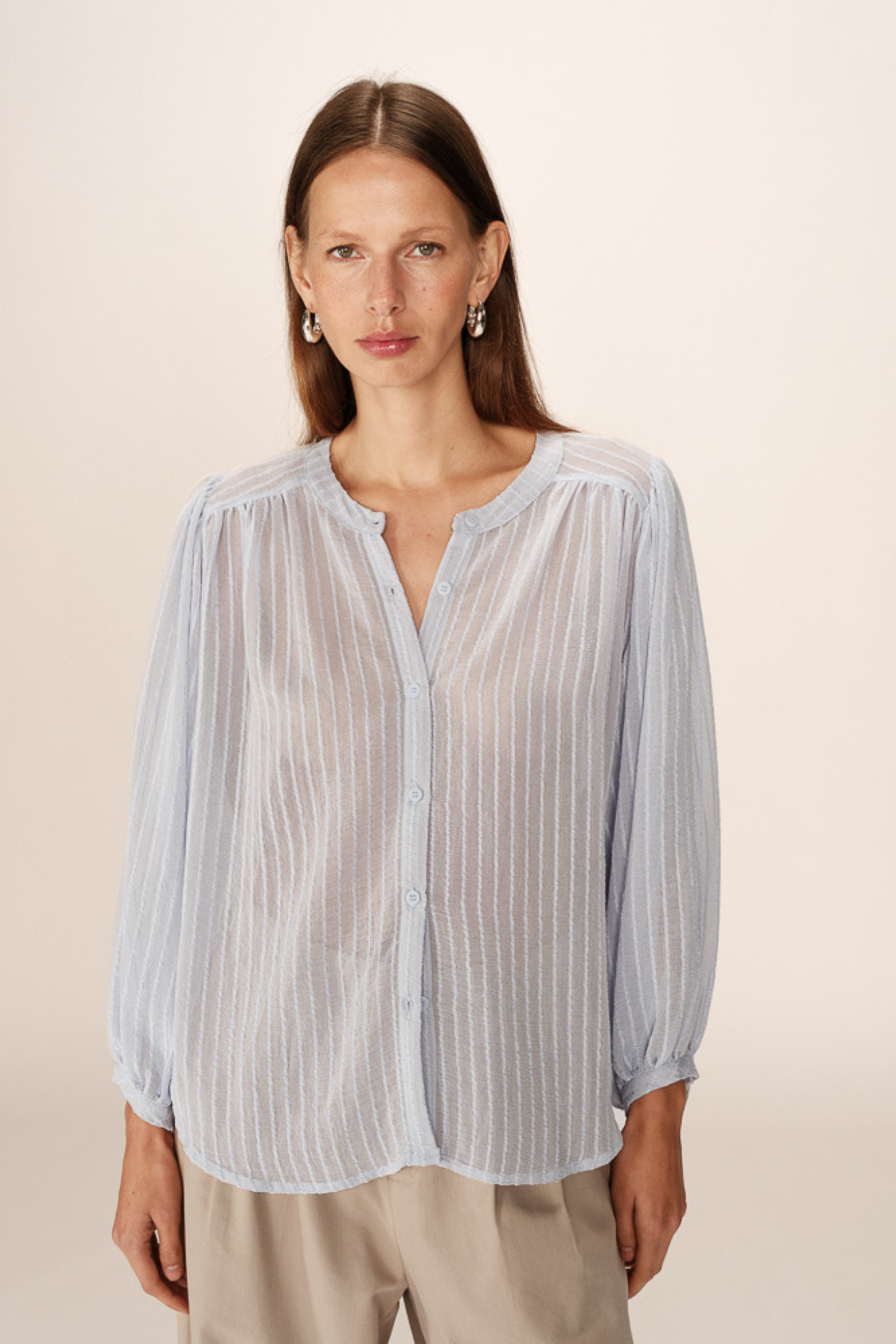 Model wearing the Grace & Mila poesie blouse in blue. Front view