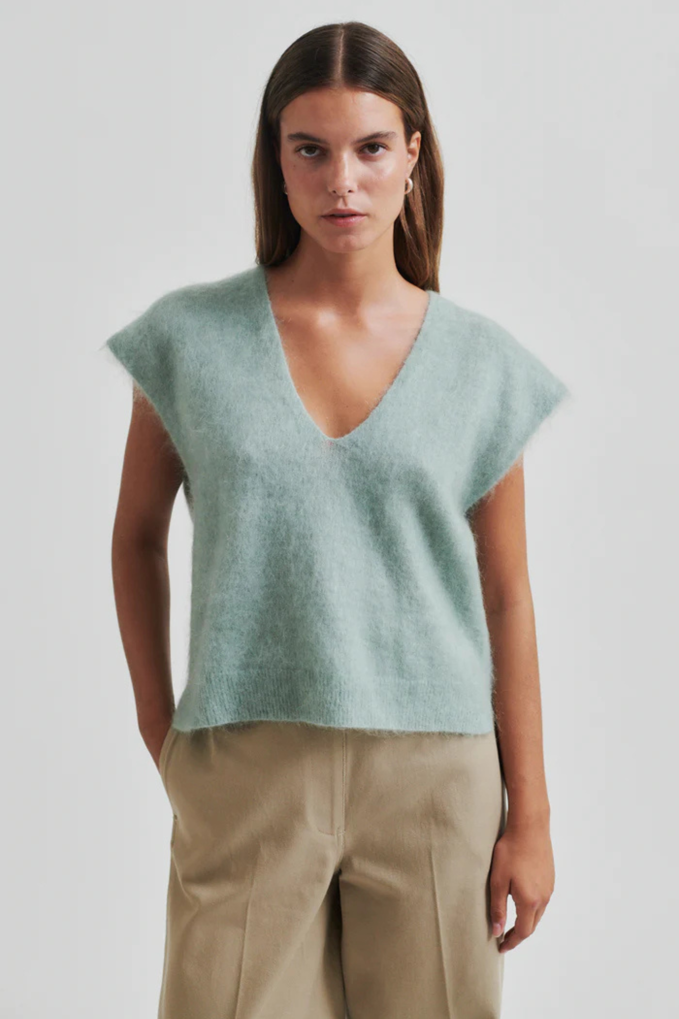 Model wearing the Second Female camryn knit vest in green. Front view