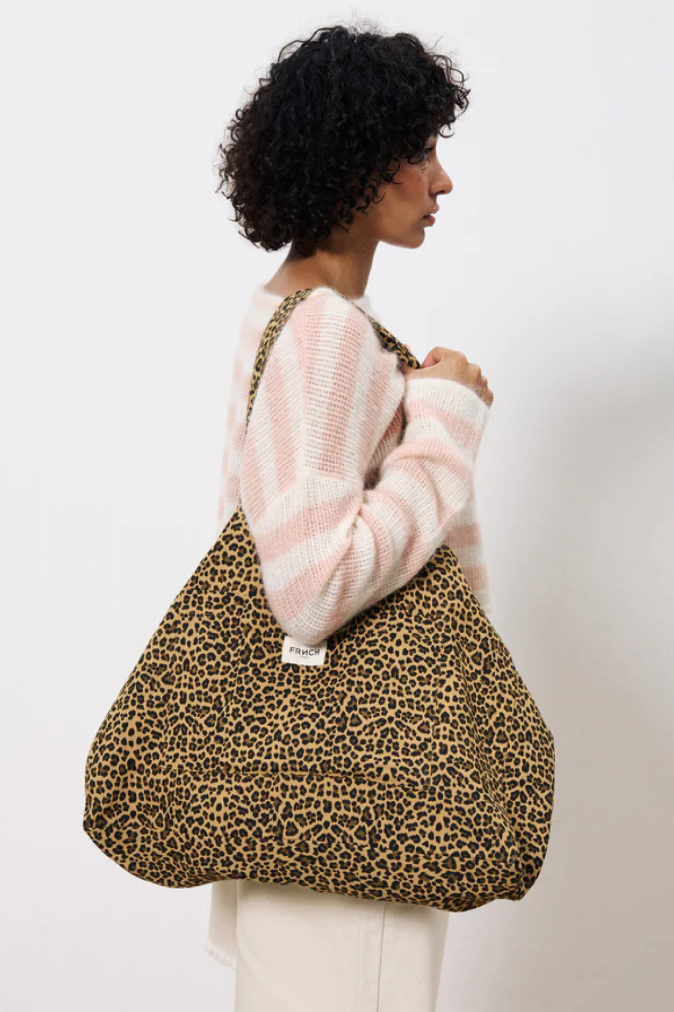 Model wearing the FRNCH vida bag in leopard. Front view